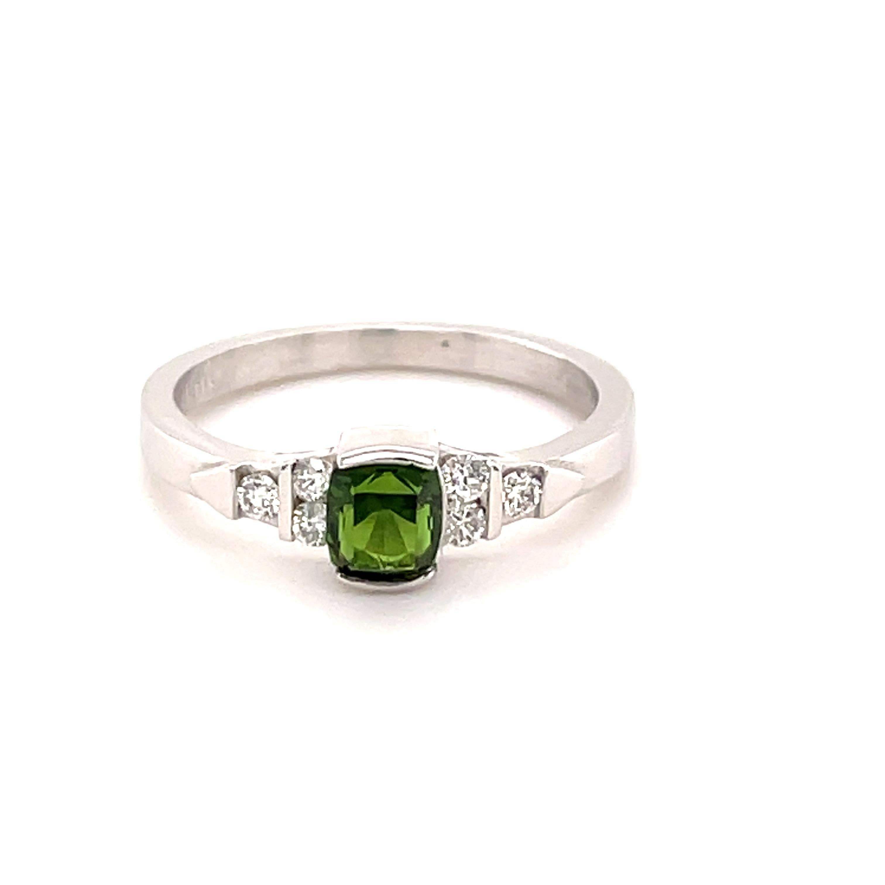 
The Chrome Tourmaline in this ring has the typical forest green color and weighs 0.58 carats with the measurements of 5.2 x 4.2 mm. The ring is done in 14-karat white gold with 6 round Diamonds VS grade and G color weighing 0.24 carats.
The size is