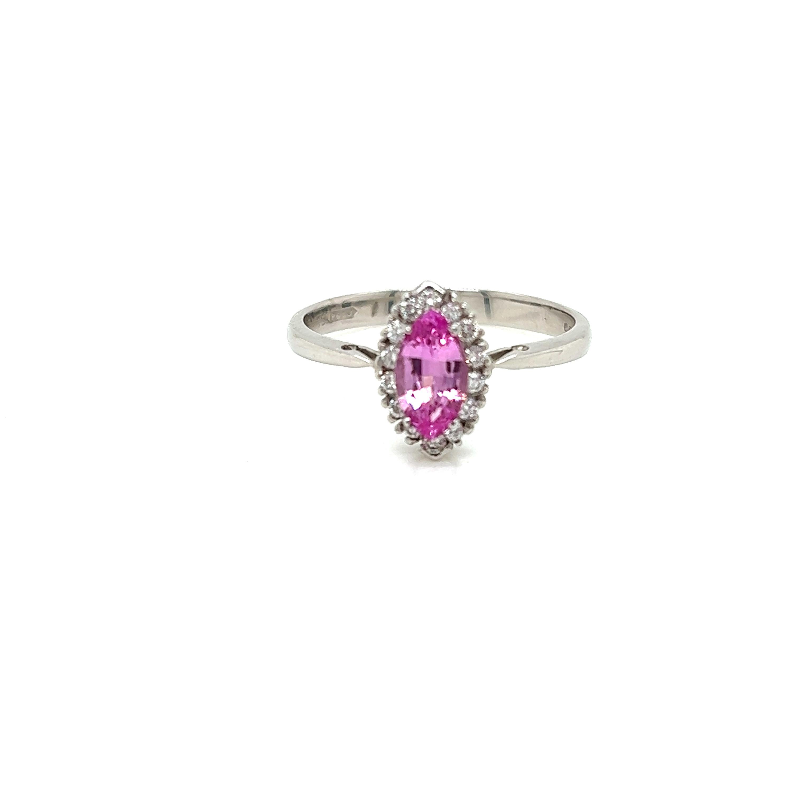 This splendid ring features a 0.58 Carat Marquise cut Pink Sapphire held in a claw setting at its centre. Surrounding the resplendent pink gemstone is 0.15 carats of Round Brilliant Diamonds, set in 18K White Gold.

The diamonds on this ring are of