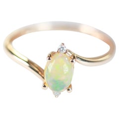 0.58 Carat Oval Cab Ethiopian Opal and Round Diamond 14 Karat Rose Gold Ring