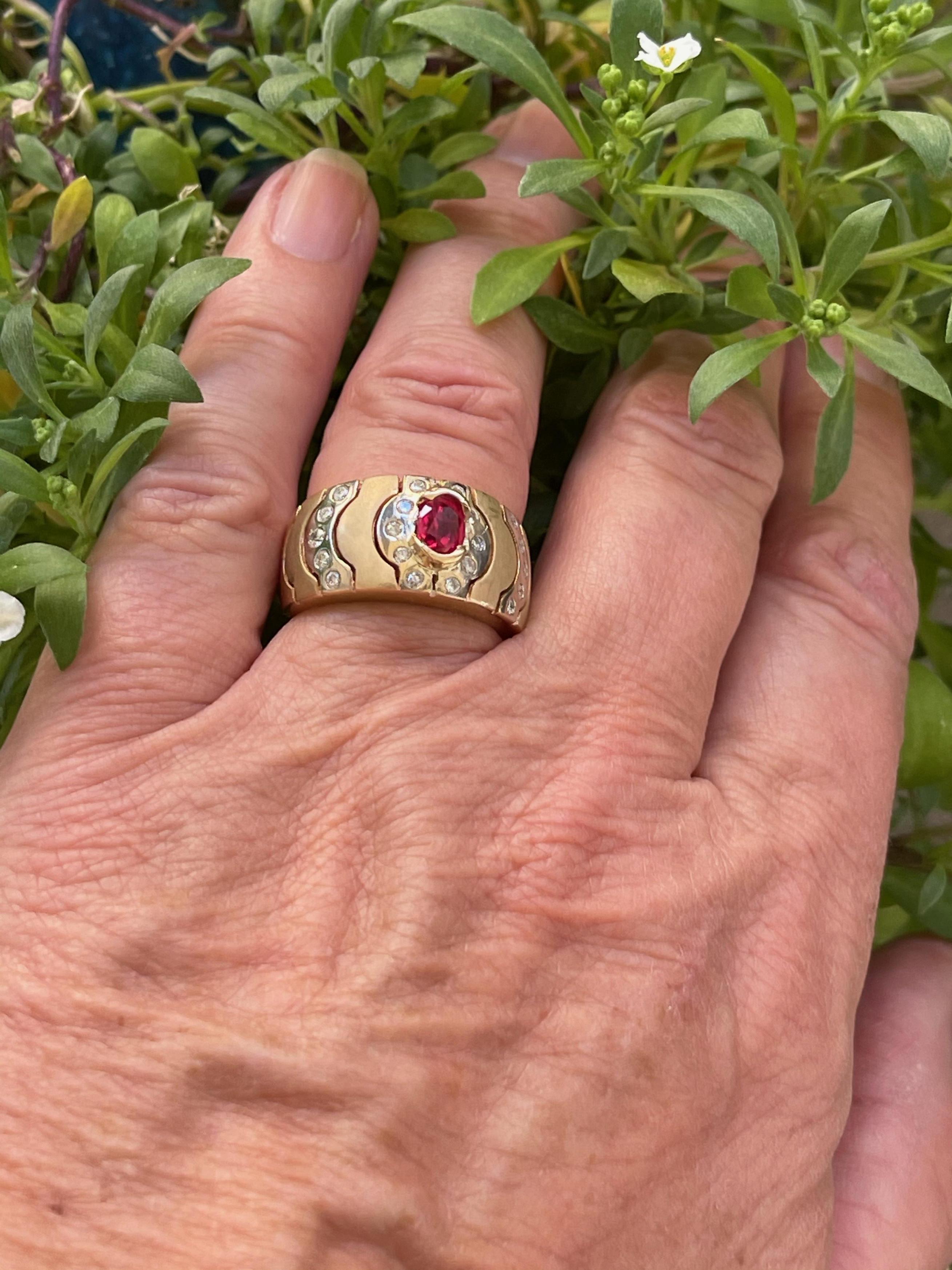We bought this modern two-tone ring in 14-karat gold. Elke liked the way the matted gold dome was done and we replaced the pongs for the center stone with half-bezels to make the design more streamlined and more wearable. The 0.58 carats red Burmis