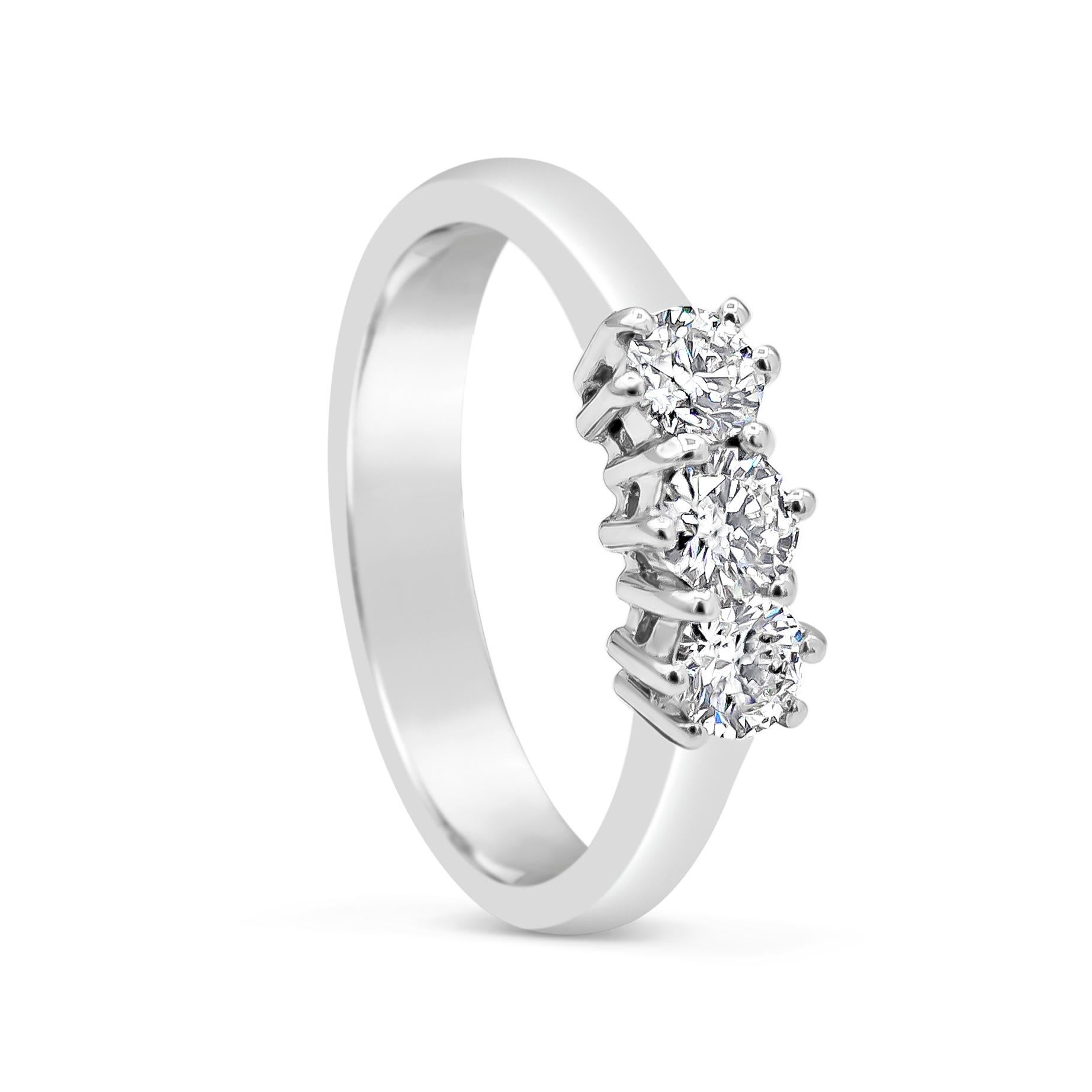 A classy and simple engagement ring style showcasing three brilliant diamonds, set in a timeless six-prong white gold setting. Diamonds weigh 0.58 carats total and are approximately G color, VS in clarity. Size 5.75 US resizable upon request.

Style