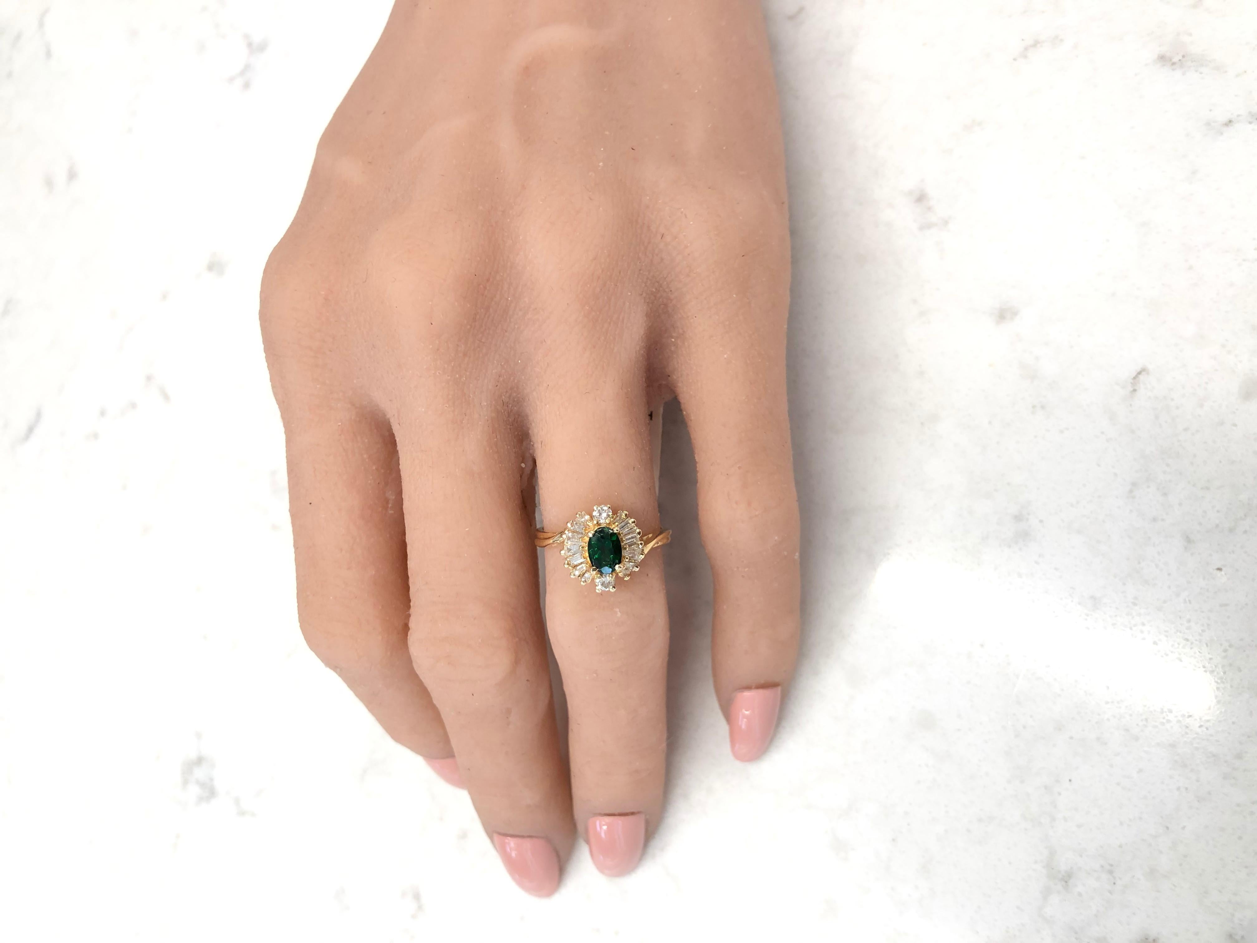 This incredible cocktail ring displays natural color and fire in a show-stopping style. Created in brightly polished 14 karat yellow gold, this beautiful ring features a 0.58 carat tsavorite garnet center stone that exhibits a green hue,