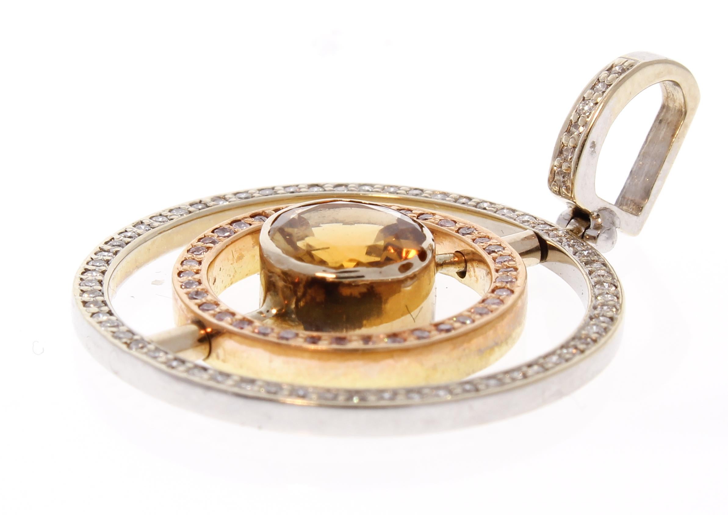 Extraordinary and versatile! That’s exactly what you'll say when you feast your eyes on this gorgeous contemporary pendant. The round citrine garnet is from Brazil. Two diamond frames featuring an the inner spinning halo to show natural pink