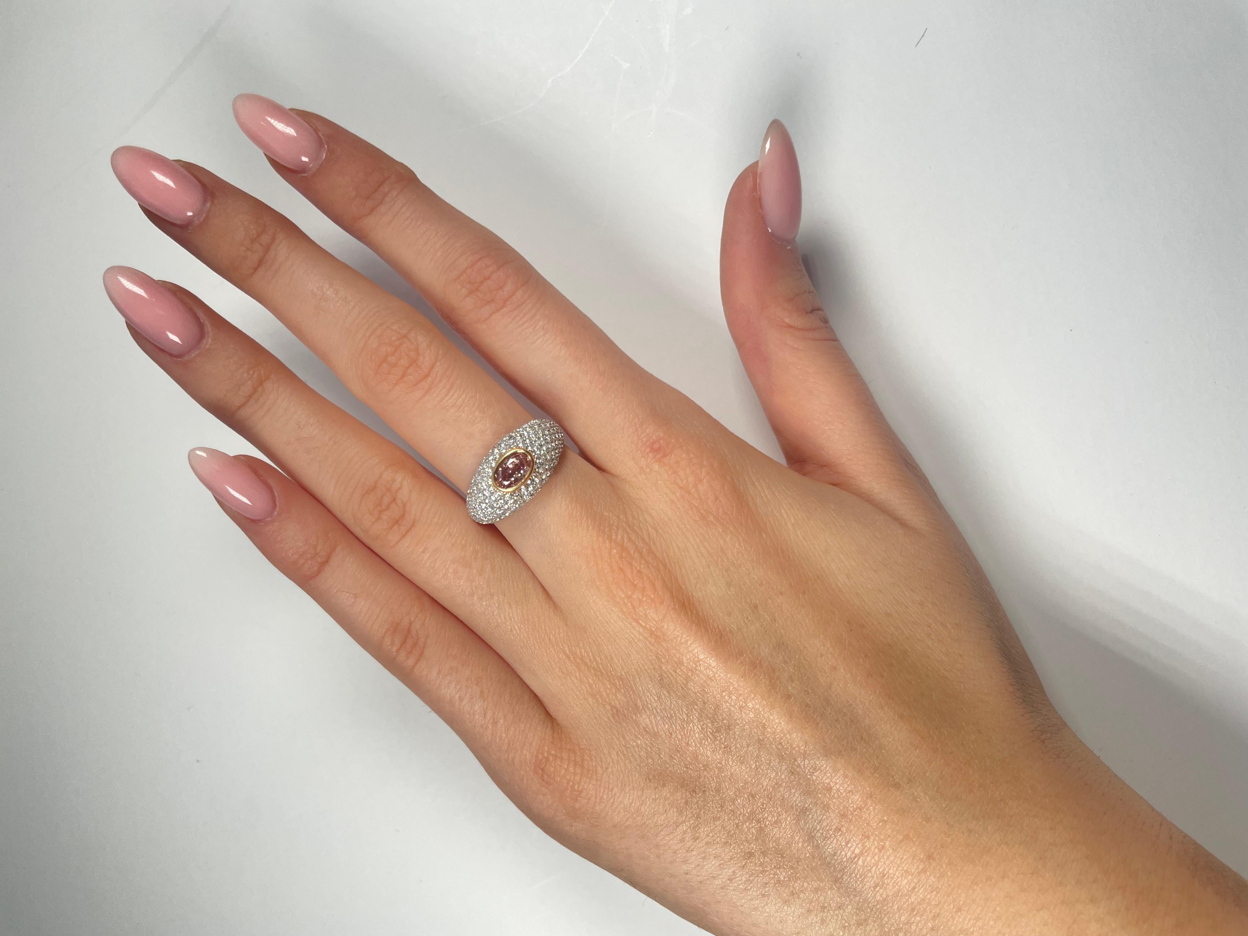 Ein einzigartiger Verlobungs- oder Cocktailring, GIA-zertifizierter 0,59 Karat Fancy Orangey Pink Oval Cut Diamant. Das klassische Design bringt die Schönheit des Mittelsteins mit den umliegenden 196 runden Diamanten F-G Farbe VS Klarheit, in einem