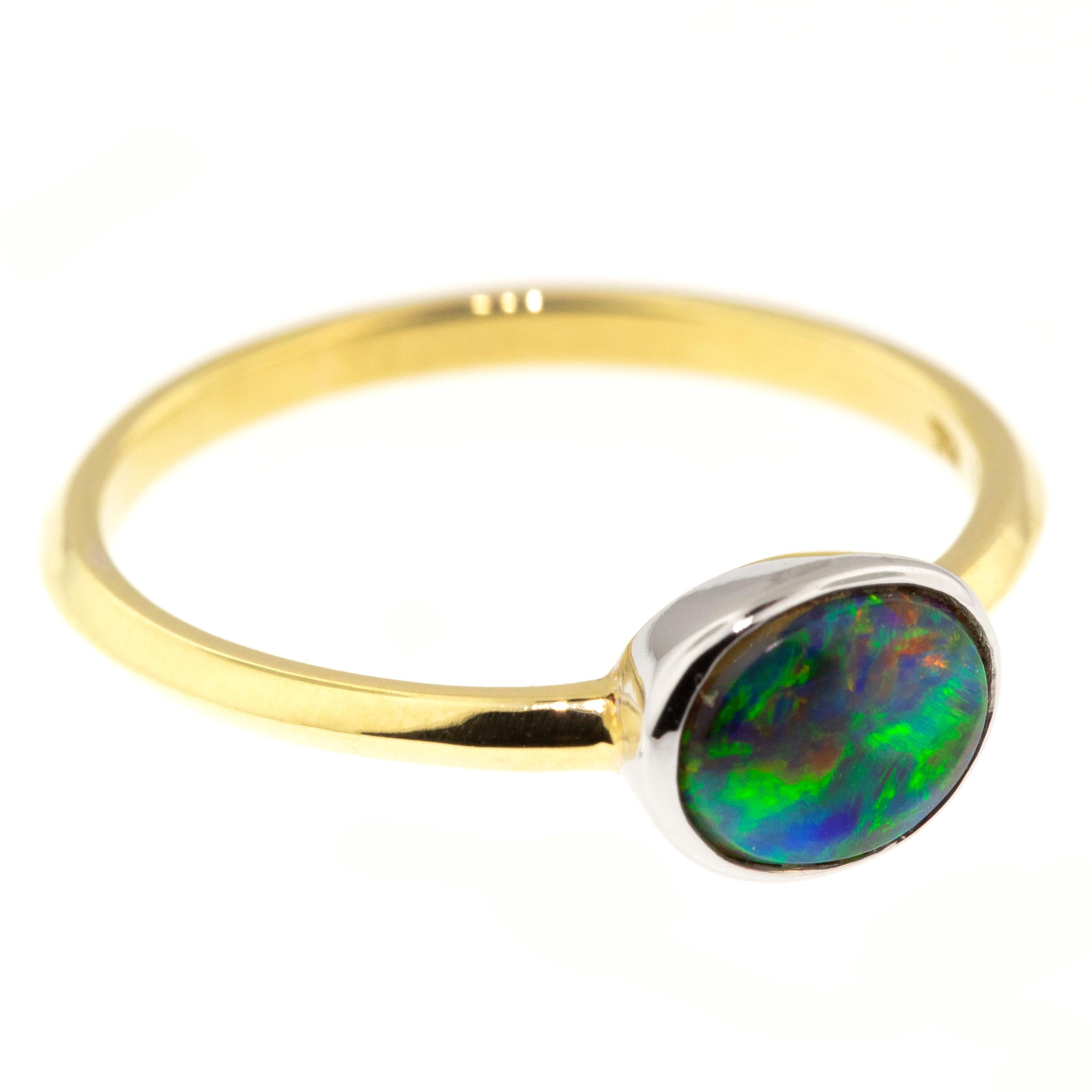 The colors of this brilliantly hued Australian black opal from Lightening Ridge have a painterly appearance, with strokes of saturated color popping from the dark background. 

