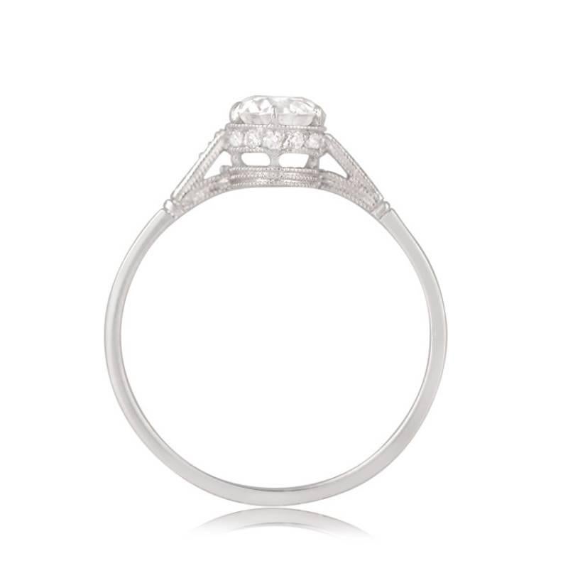 A delicate engagement ring featuring an old European cut diamond weighing 0.59 carats, G color, and SI1 clarity. Smaller old European cut diamonds embellish the shoulders and under-gallery. Handcrafted in platinum, this ring exudes timeless