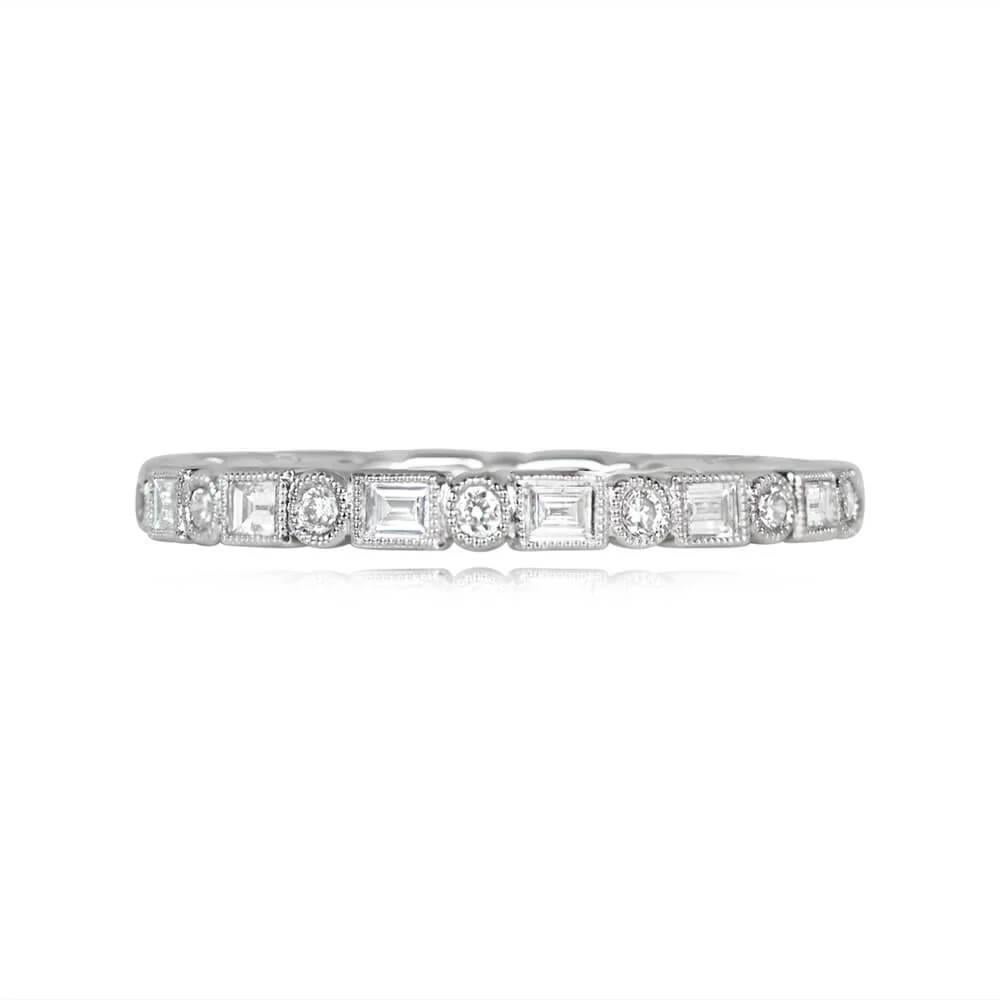 A delicate platinum eternity band showcasing alternating round brilliant cut and baguette cut diamonds. Each diamond is bezel-set with fine milgrain detailing. The total approximate diamond weight of this band is 0.59 carats.

Ring Size: 6.25 US,