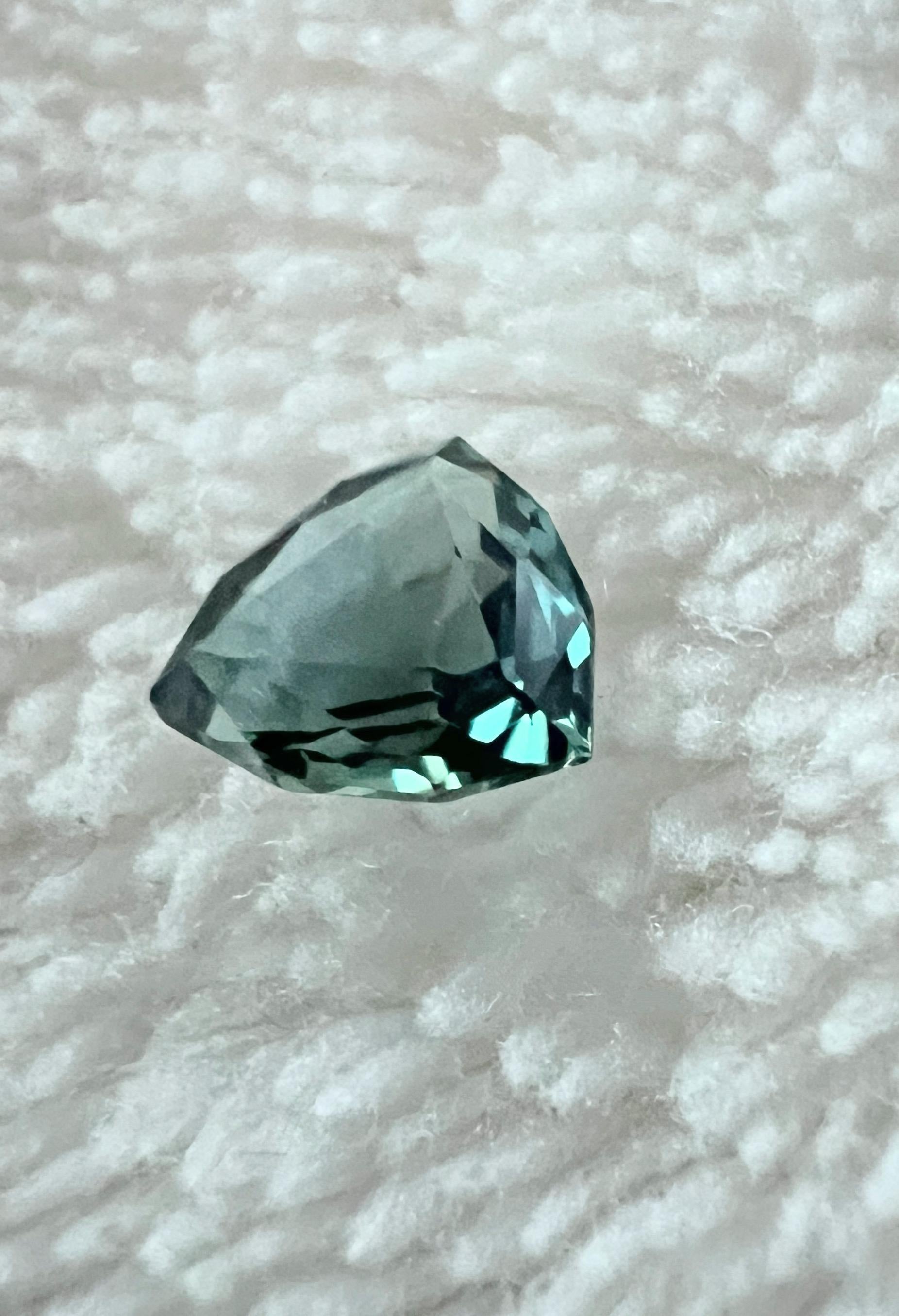 The enchanting allure of our 0.5-carat Trillion Cut Natural Teal Blue Sapphire. This LOUPE CLEAN gemstone is a symphony of sophistication and color, destined to captivate hearts with its unique charm.

Key Features:
Gemstone Weight: 0.5 carats
Cut: