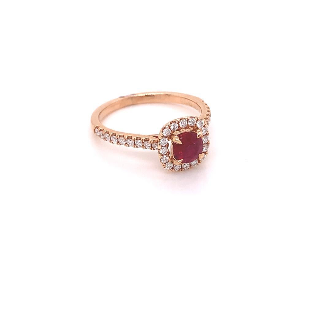This Fabulous ring features a Regal Round Brilliant Ruby weighing 0.6 carats surrounded by a cushion of Glittering Halo Diamonds and set in 18k Rose Gold. Studded along the Rose Gold Band is a row of Shoulder Diamonds which add Opulence to the Ring.