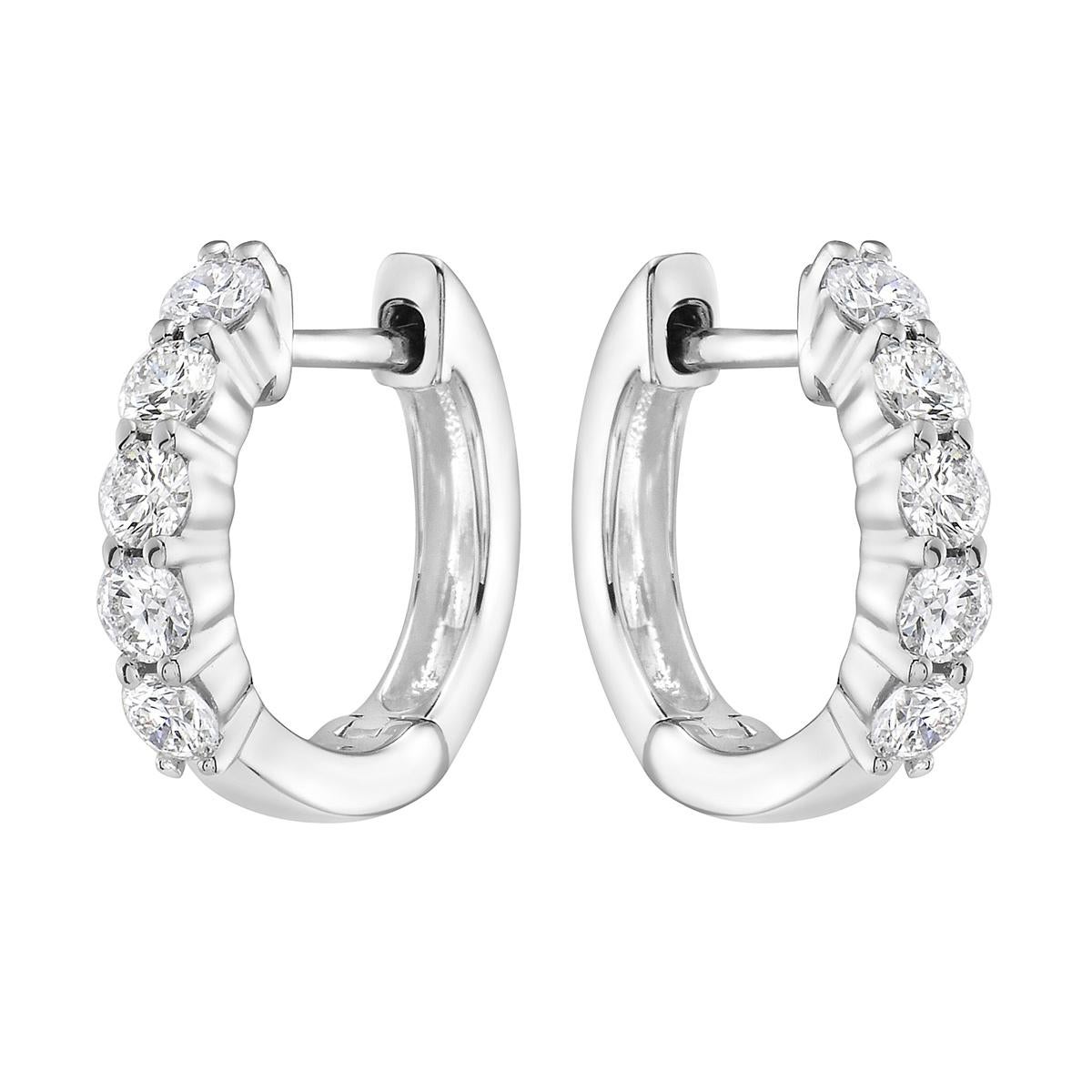With these exquisite white-gold diamond hoops, style and glamour are in the spotlight. These hoops are set in 18-carat gold, made out of 3.3 grams of gold. The color of the diamonds is G. The clarity is VS2. These earrings are made out of 10