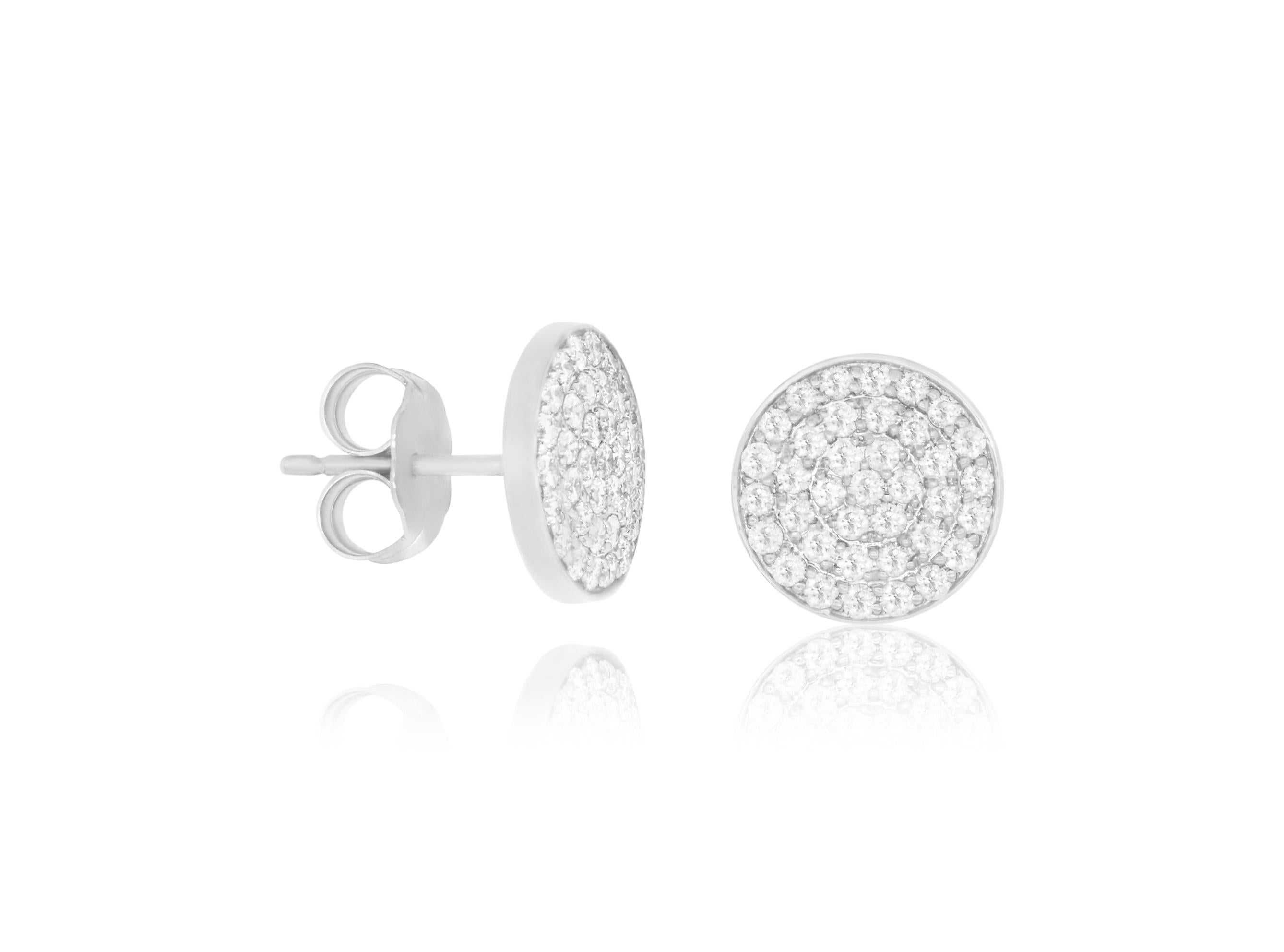A spin on the classic diamond earrings! These diamond disc studs feature 74 diamonds and sparkle and shine at 0.60 carats. 

Material: 14k White Gold 
Stone Details: 74 Brilliant Round Diamonds at 0.60 Carats

Fine one-of-a kind craftsmanship meets