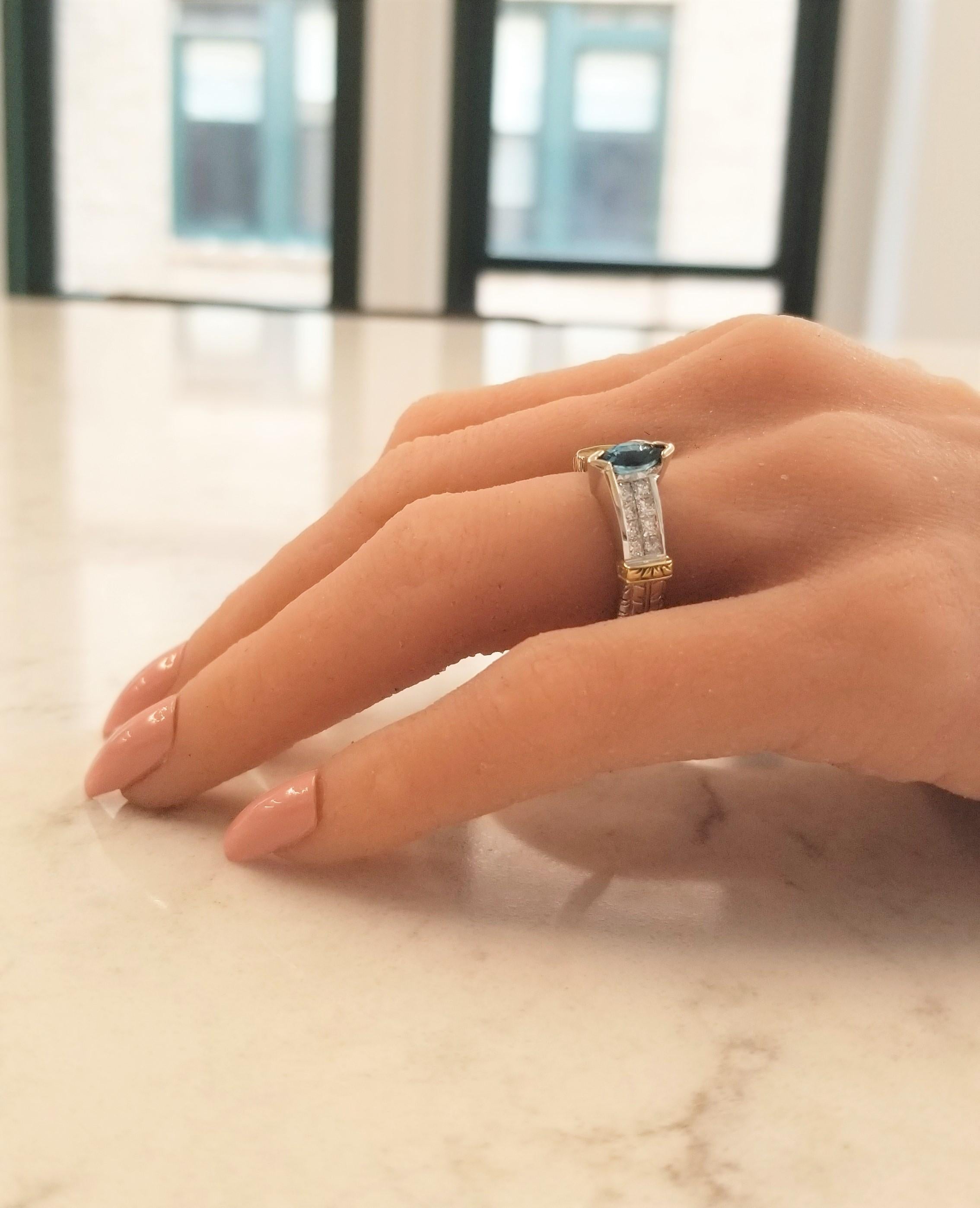 Blue Topaz and diamonds unite, to create this outrageously stunning ring. The richly hued and distinctively designed 18 Karat white and yellow gold mounting is unique and elegant. The combination of gold creates a dynamic look. It securely holds a