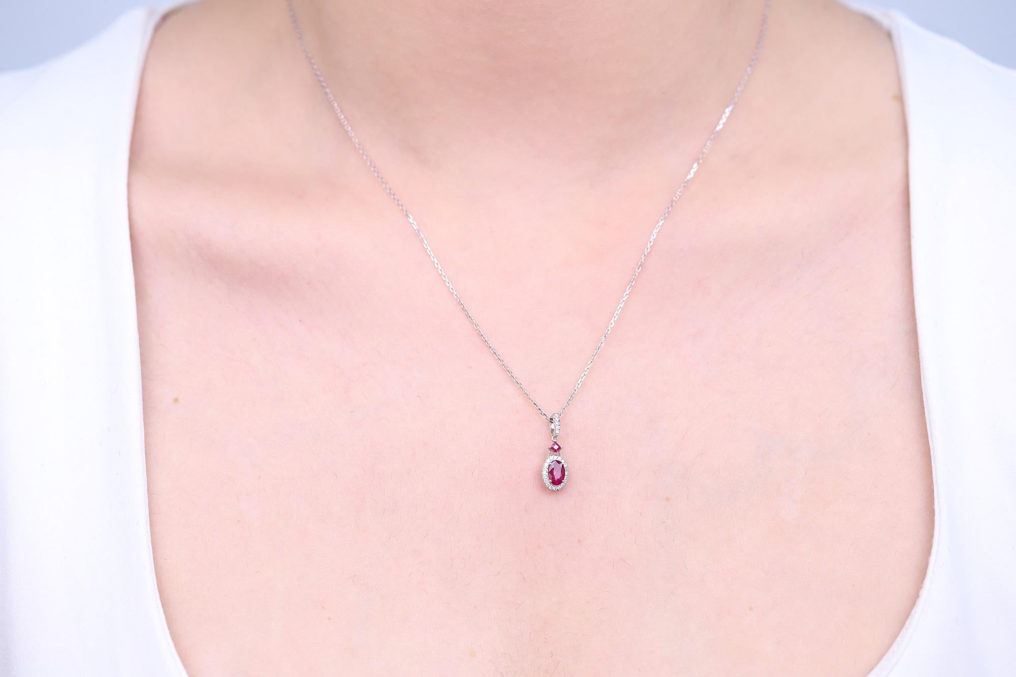 Decorate yourself in elegance with this Pendant is crafted from 10-karat White Gold by Gin & Grace Pendant. This Pendant is made up of 6x4 mm Oval-Cut Ruby (1Pcs) 0.55 Carat, 2.0 mm Square-cut Ruby (1 Pcs) 0.07 Carat and Round-cut White Diamond (25