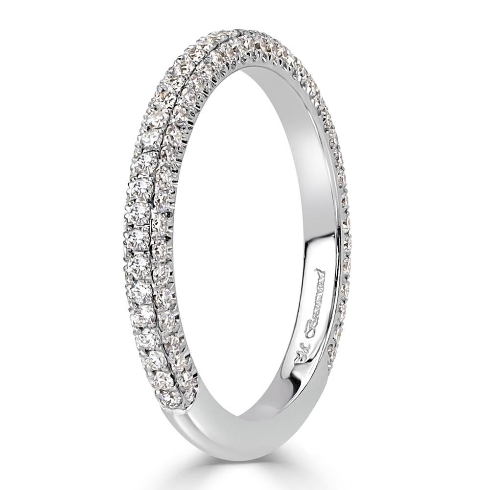This enchanting diamond wedding band features three rows of round brilliant cut diamonds micro pavé set in 18k white gold. The diamonds total 0.60ct in weight and are graded at E-F colors, VS1-VS2 clarities.