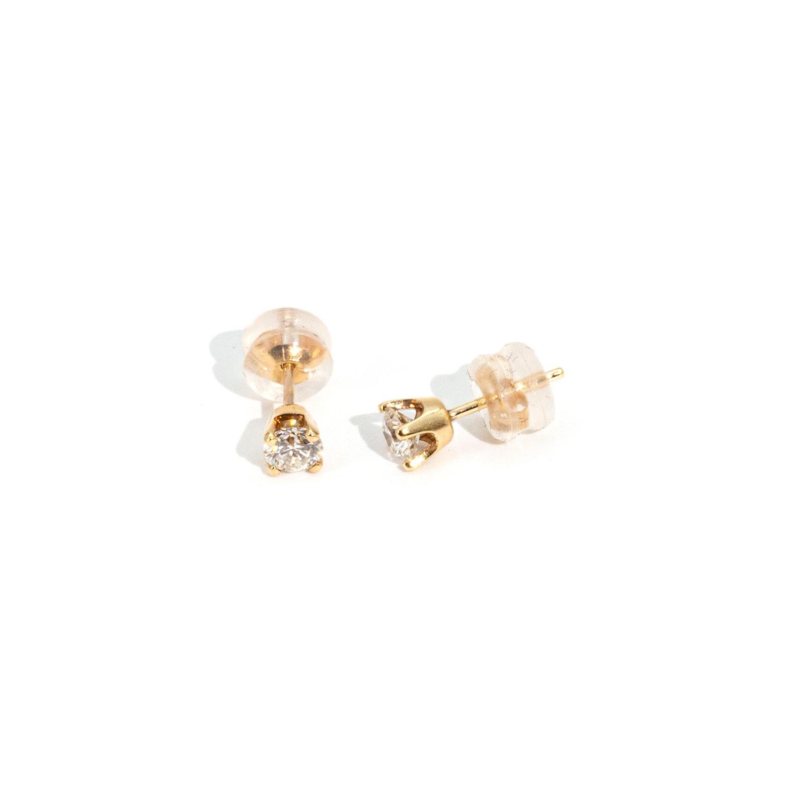 Crafted in 9 carat yellow gold is this classically elegant pair of stud style earrings that feaure two round brilliant cut diamonds totalling 0.60 carats.  The studs are finished with standard 9 carat posts and 10 carat yellow gold butterfly