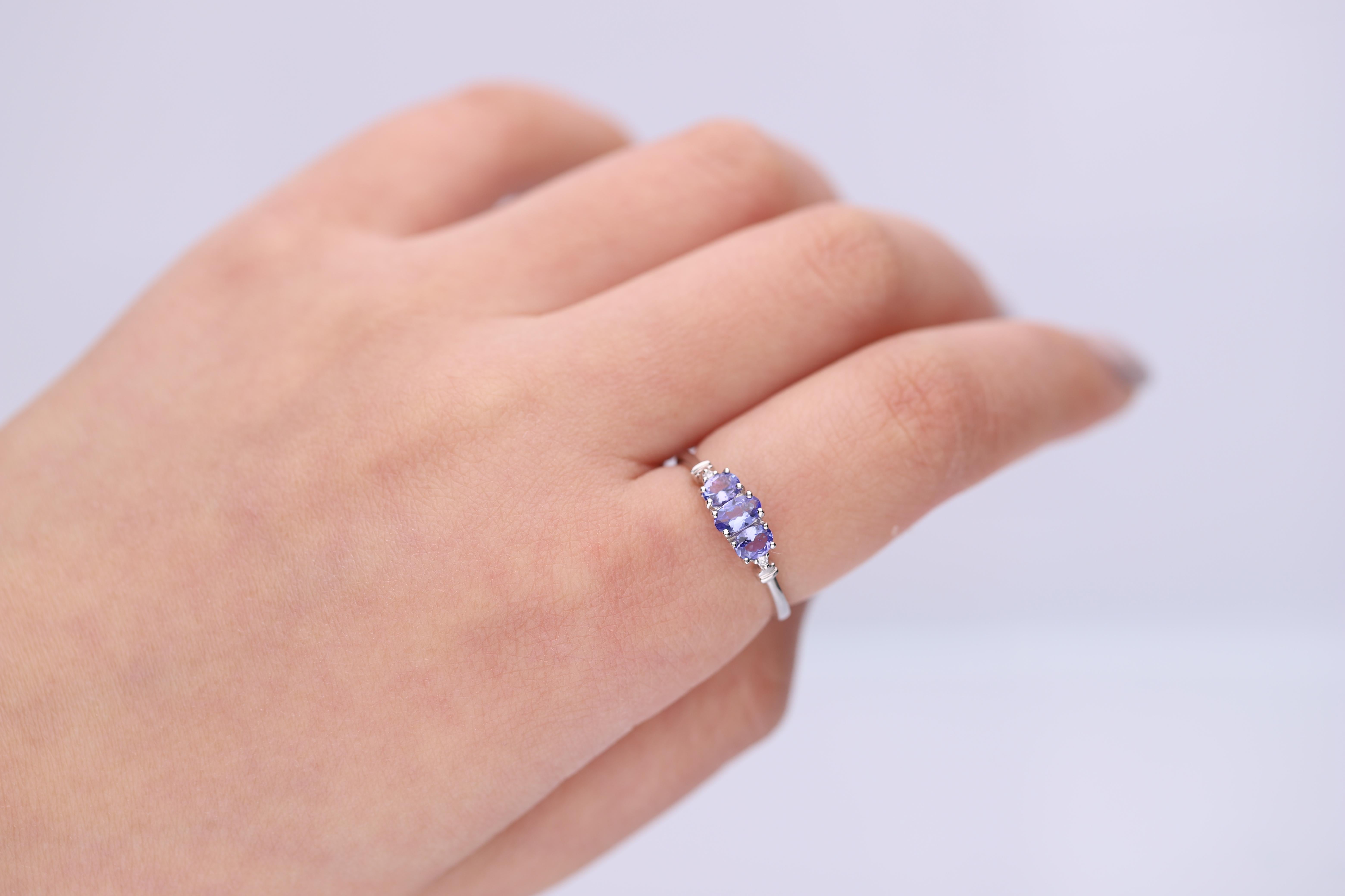 Decorate yourself in elegance with this Ring is crafted from 10-karat White Gold by Gin & Grace. This Ring is made up of 5x3 mm oval-cut (1 pcs) 0.24 carat,4x3 mm Oval-Cut (2 pcs) 0.36 carat Tanzanite and Round-cut White Diamond (2 Pcs) 0.02 Carat.