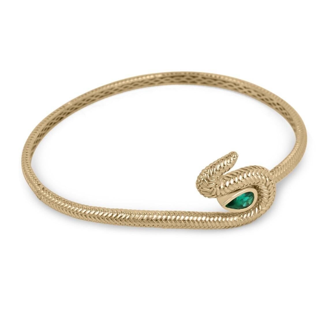 Introducing the exquisite Emerald Snake Cuff Bracelet, a masterpiece of jewelry designed by the talented Natalie Rodriguez. This captivating cuff bracelet is adorned with intricate snake scales, exuding an aura of mystique and allure. At its heart,