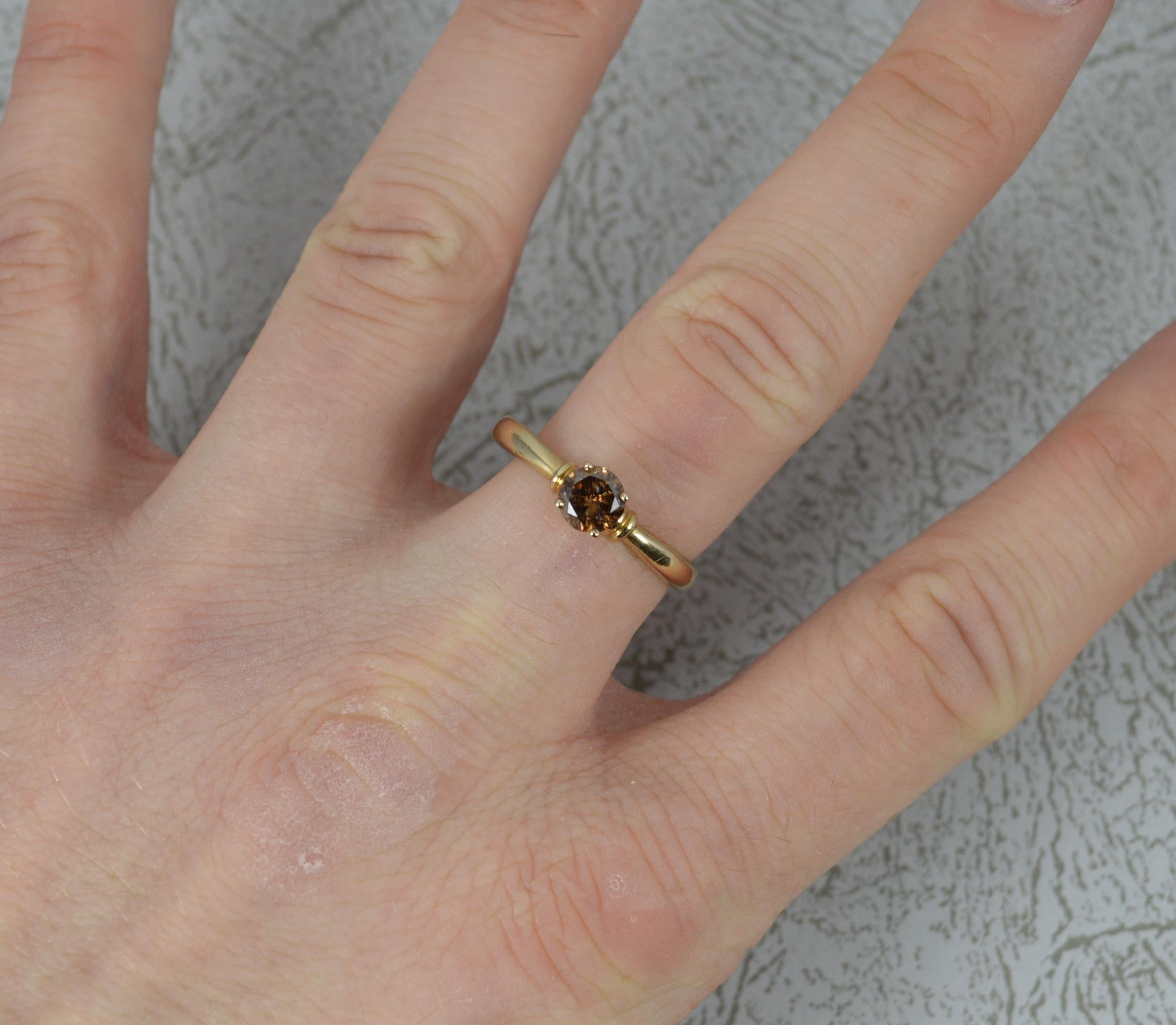 A large and natural Diamond and 9ct Gold ring.
​Set with a round brilliant cut diamond to measure 5.5mm in diameter in a four claw setting. 0.60 carats.
All modelled in a 9 carat yellow gold throughout.
Protruding 5.1mm off the finger.
Obvious