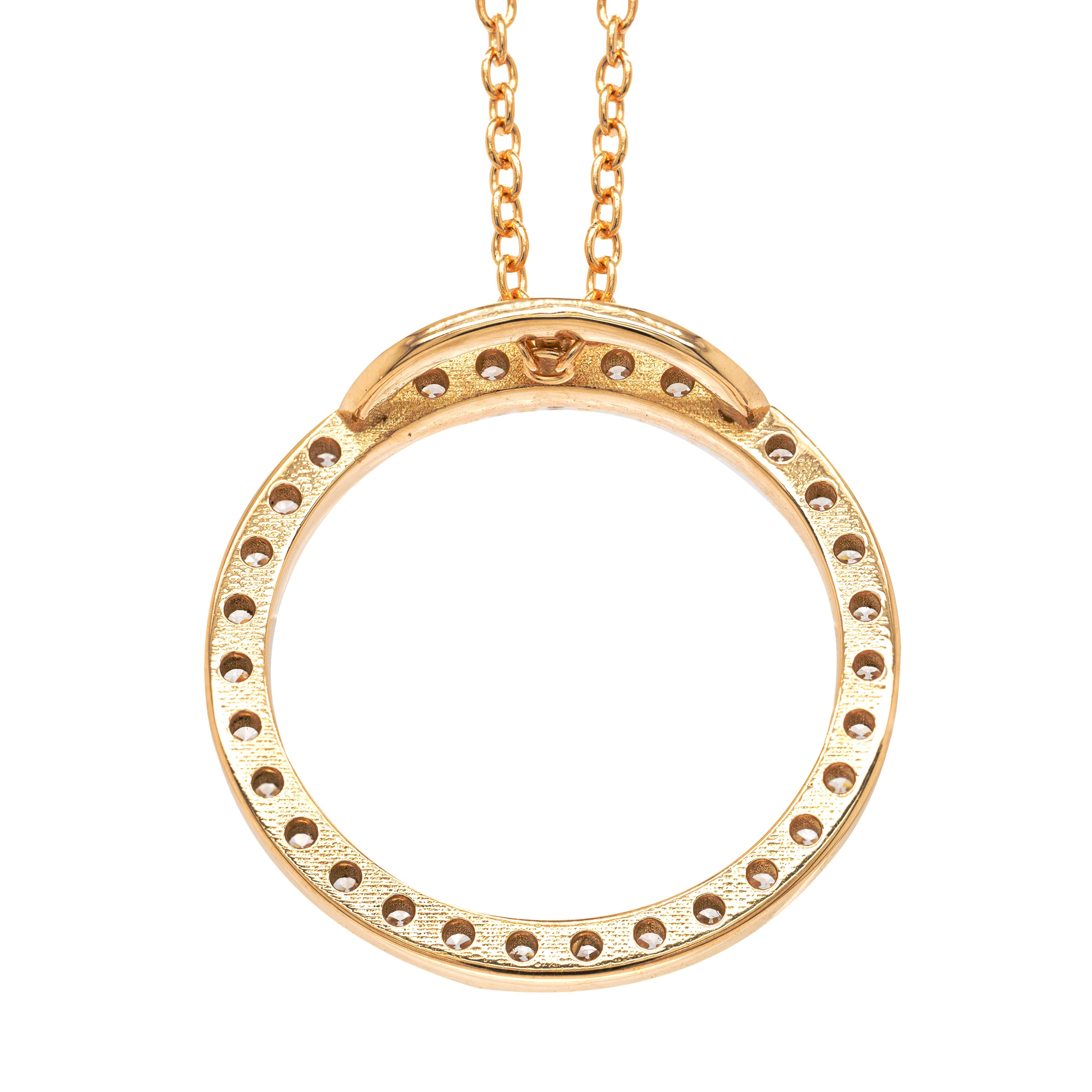 This beautiful 18 carat yellow gold necklace features a diamond set circle pendant measuring 19.8mm in diameter. The pendant is beautifully inlaid with 31 fine quality round brilliant cut diamonds coming to a total weight of 0.60ct. To accompany the