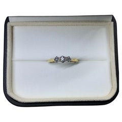 0.60ct Round diamond trilogy engagement ring in 18k yellow gold.