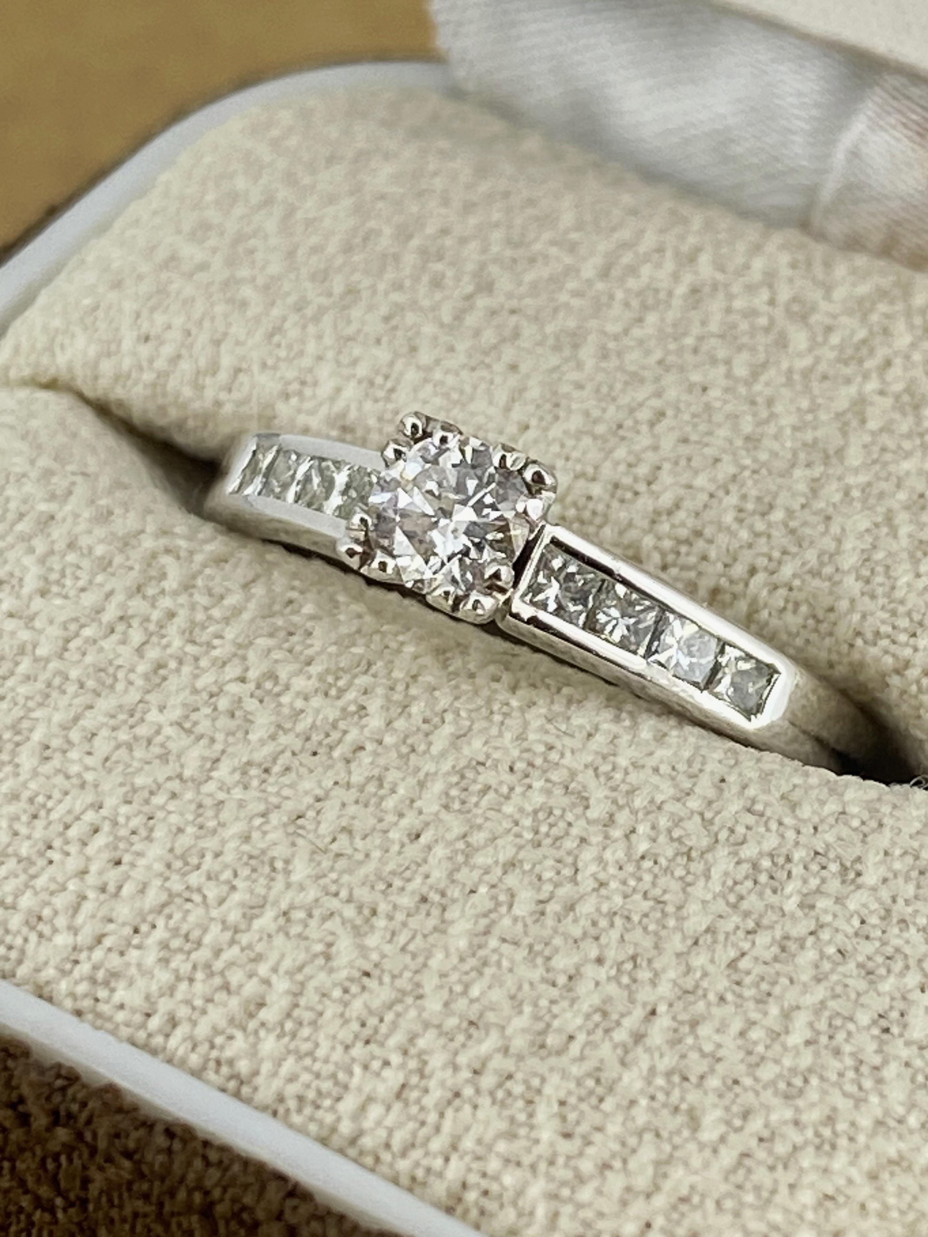 Of timeless & visually striking 
Solitaire with Accents design 
this piece is centrally set with 
a sparkling Round Brilliant Cut Diamond – 
of impressive size - 0.25ct 
of G colour, VS clarity & sun-like brilliance, 

Securely set in 18K White Gold