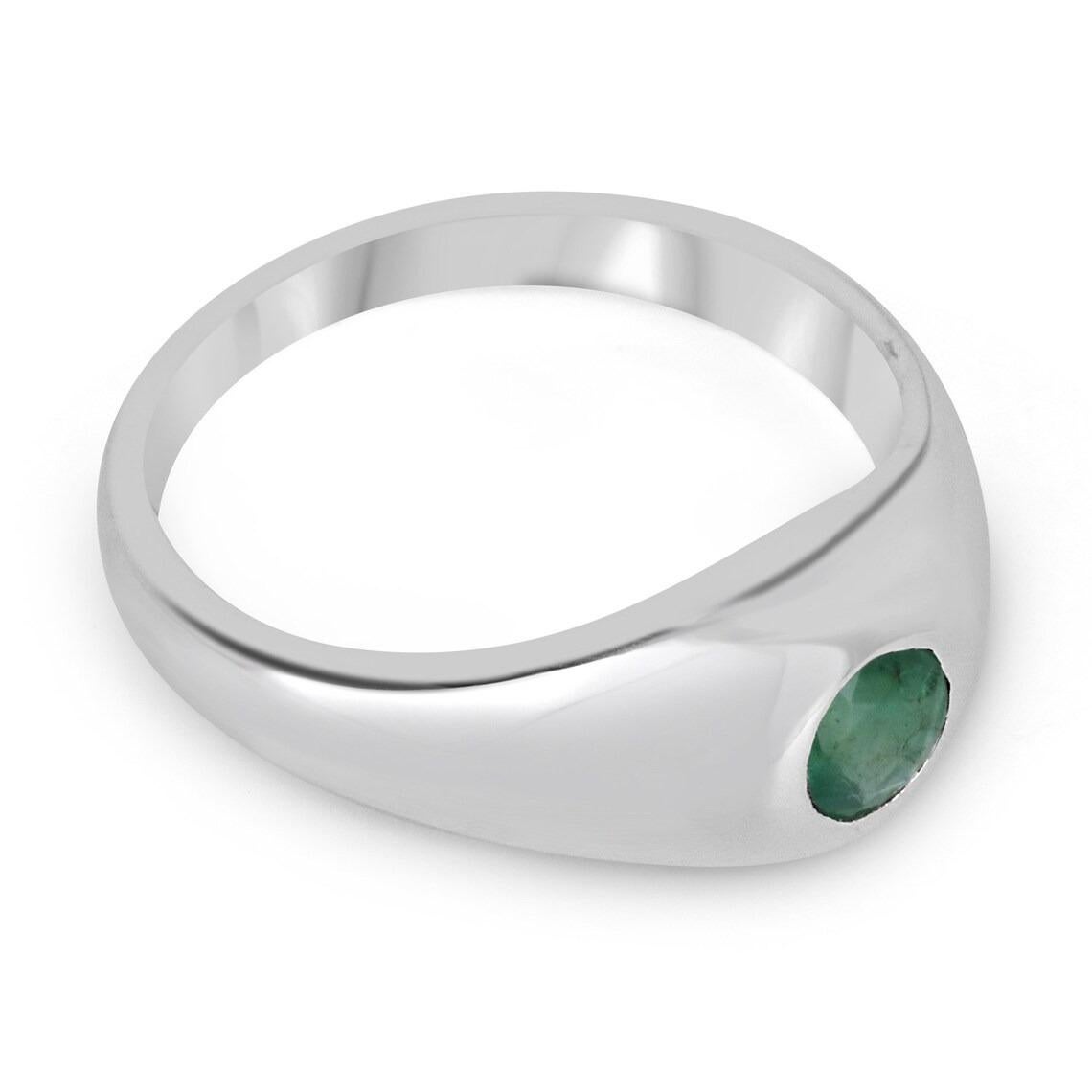 A lovely solitaire emerald ring; featuring a round-cut emerald from the origin of Zambia. The gemstone showcases a gorgeous medium-dark green color with good clarity and luster. Set in a secure solitaire bezel setting crafted in sterling