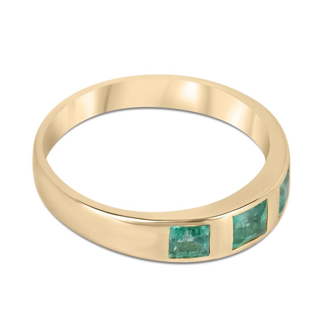 A dainty woman's emerald three-stone ring. This beauty features three natural princess cut emeralds with medium vivid green color and very good luster with a combined total carat weight of 0.60 carats. Bezel set in 14K gold, this is the perfect ring
