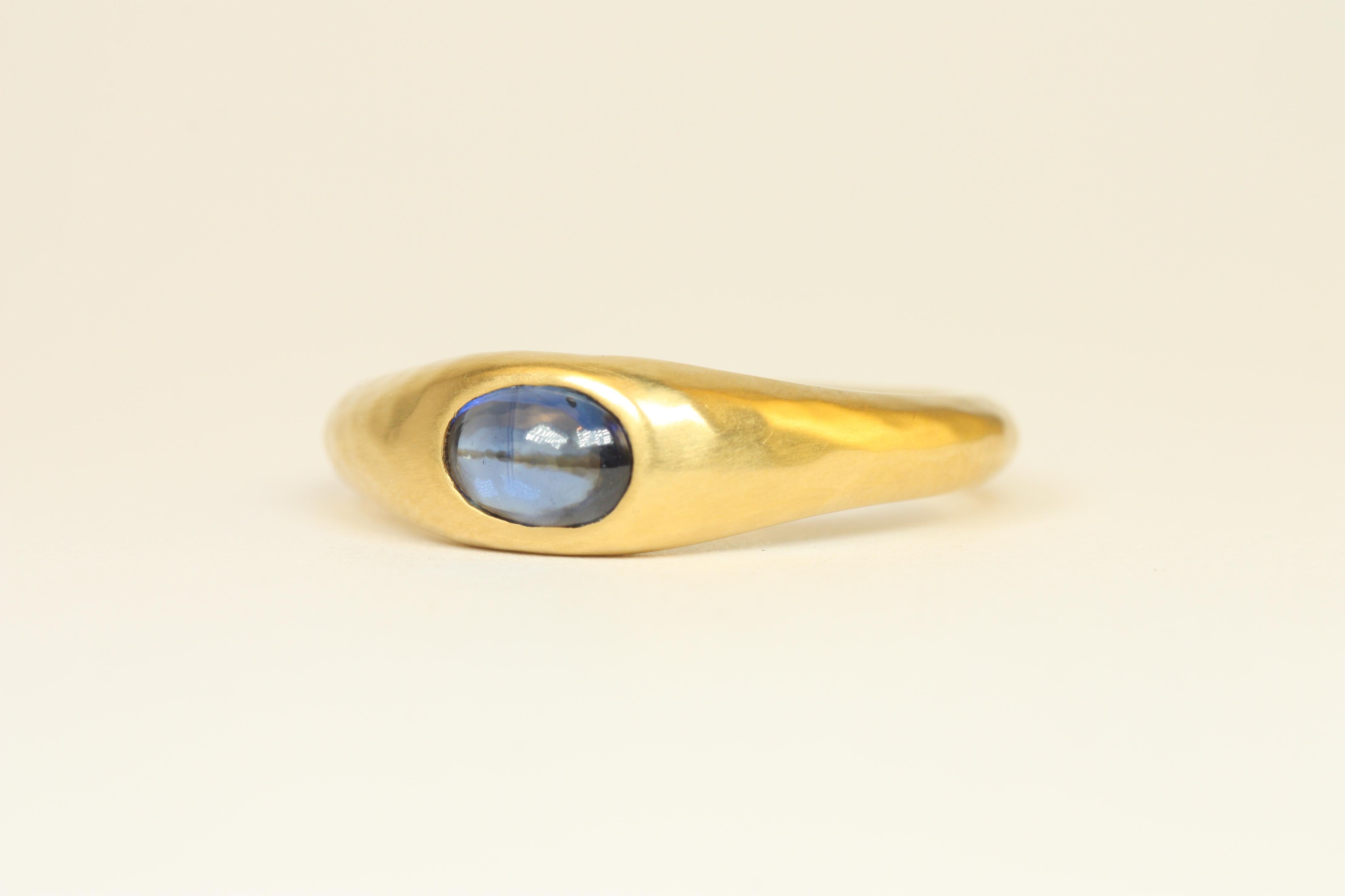 This modern gypsy ring is set with a beautiful oval cabochon cut deep light blue sapphire. Set in rich and warm 22k yellow gold, the ring offers uniqueness and and ancient feel. Thoughtfully designed and crafted, the shape and weight of the tapered