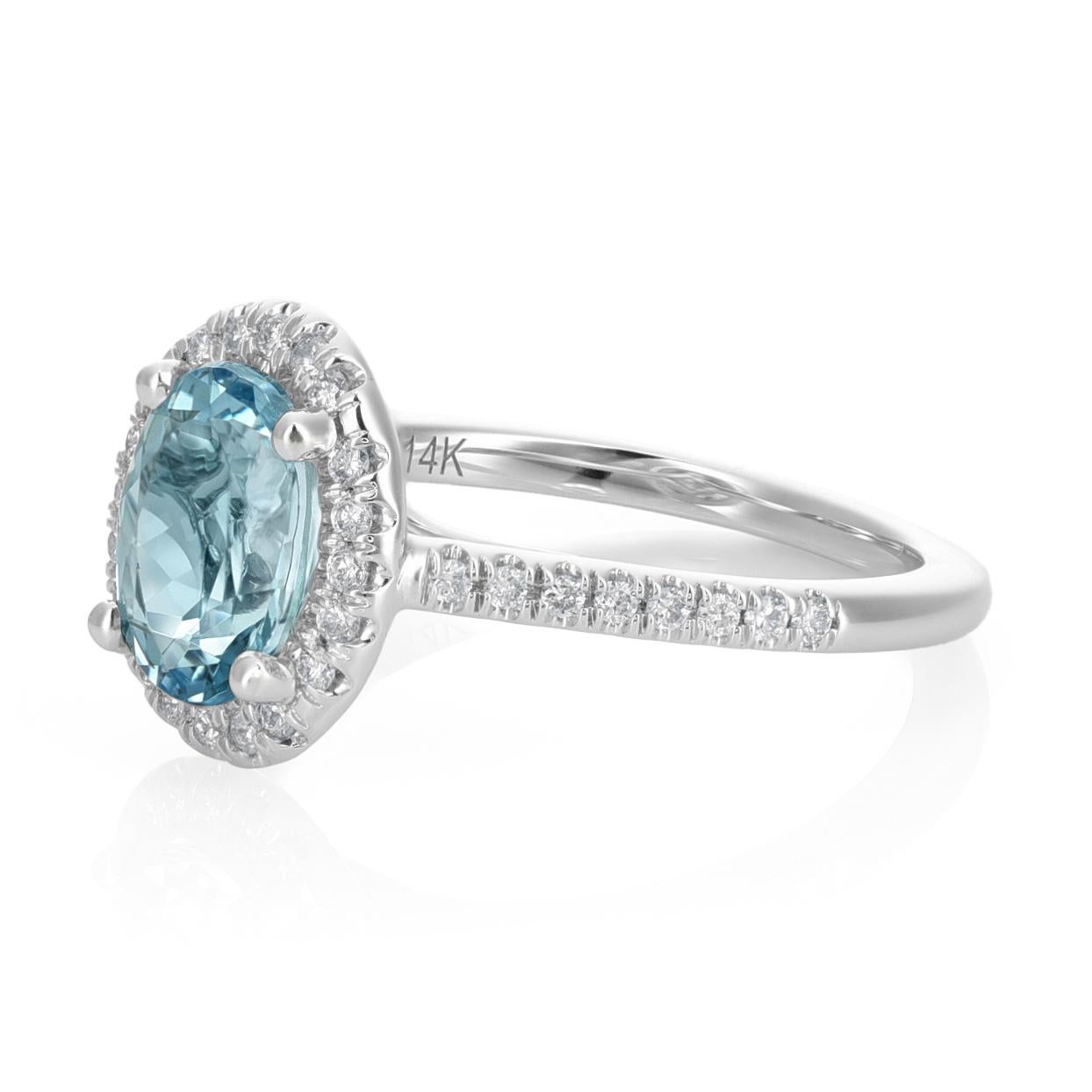 Delight in the allure of this 14K White gold ring featuring  0.61 carats natural oval-cut aquamarine. The aquamarine's captivating hue is heightened through a careful heating process. Complementing the centerpiece, 0.17 carats of diamonds encircle