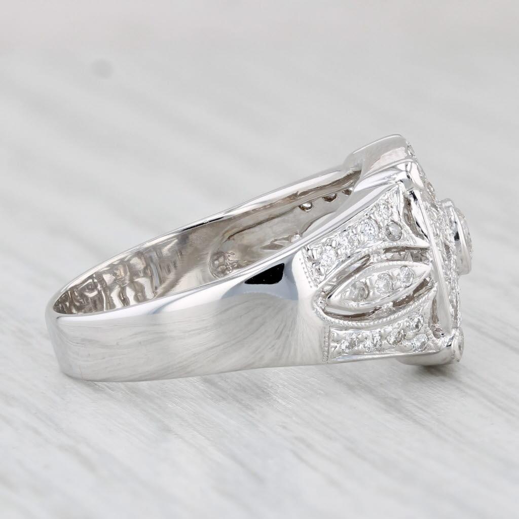 Gemstone Information:
- Natural Diamonds (center) -
Carats - 0.16ct  
Cut - Round Brilliant
Color - H - I
Clarity - VS2 

- Natural Diamonds -
Total Carats - 0.45ctw
Cut - Round Brilliant & Single
Color - G - I
Clarity - VS2 - I3

Metal: 18k White