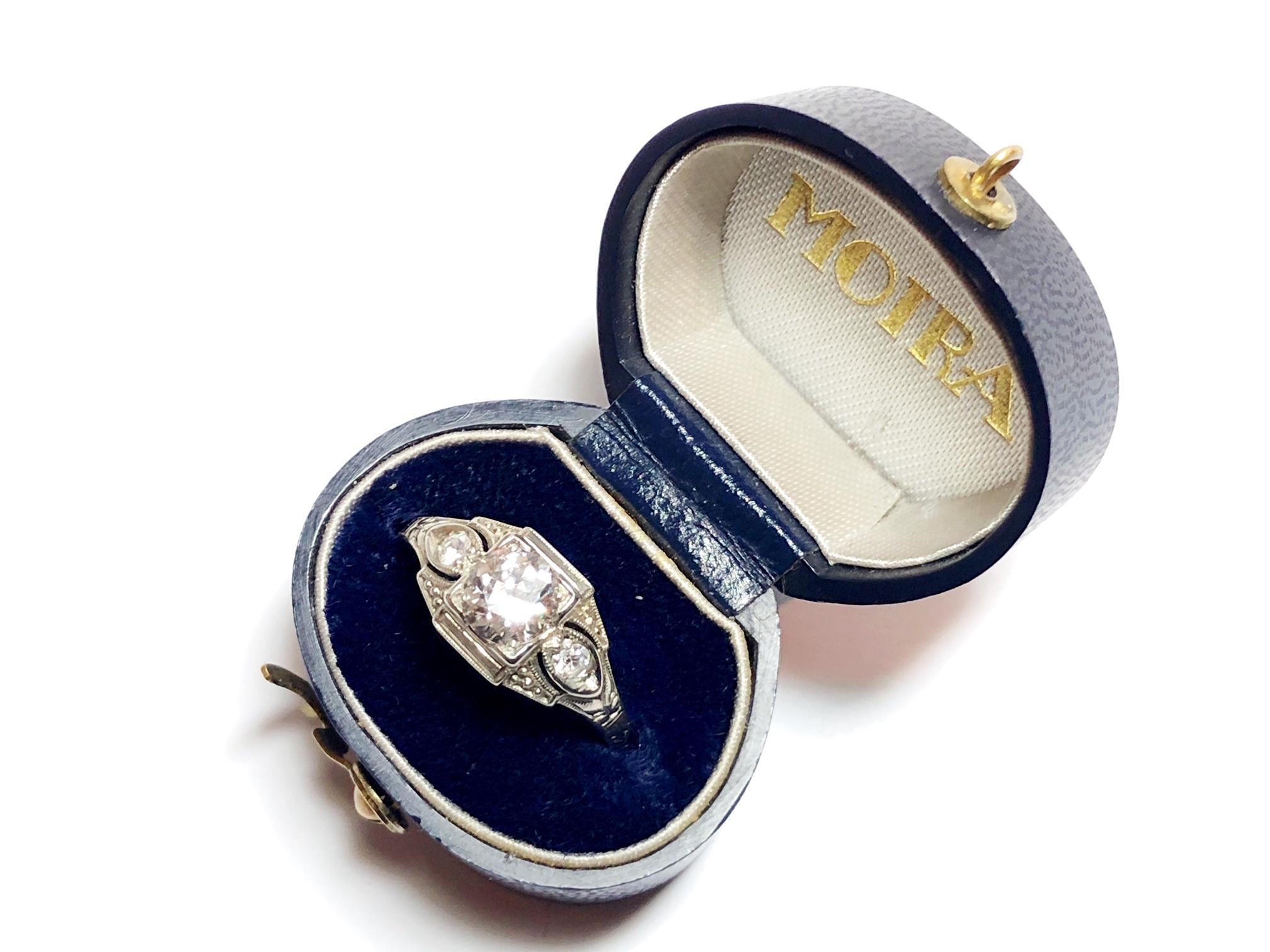 An Art Deco diamond ring, set with a 0.62ct, E-F colour, VS2 clarity, Edwardian-cut diamond, with an eight-cut diamond in each engraved, millegrain edged, openwork shoulder, mounted in 18ct white gold, stamped 18KT, accompanied by EGL certificate