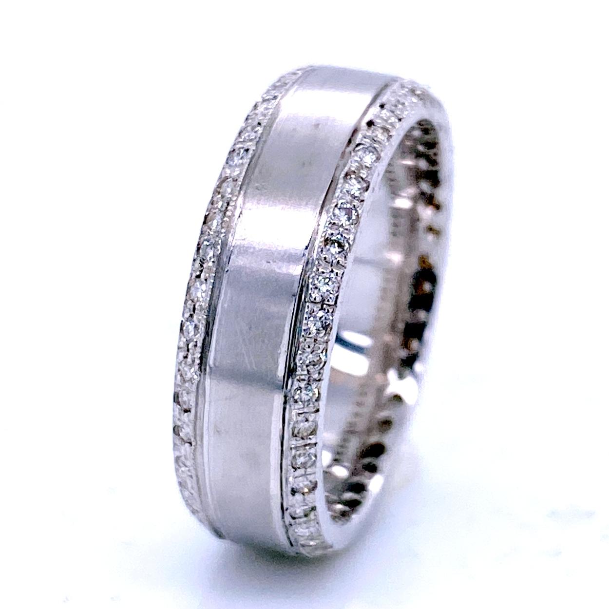 This Beautiful Gent's ring is made in 18K white gold with mat finish middle. It has 74 pieces of perfectly matched 1 mm Round Brilliant Diamonds(Total Weight 0.62 Ct) Pave set on the sides. 
Total Diamond Weight: 0.62 Ct VS2-SI1/G-H
Total Weight of