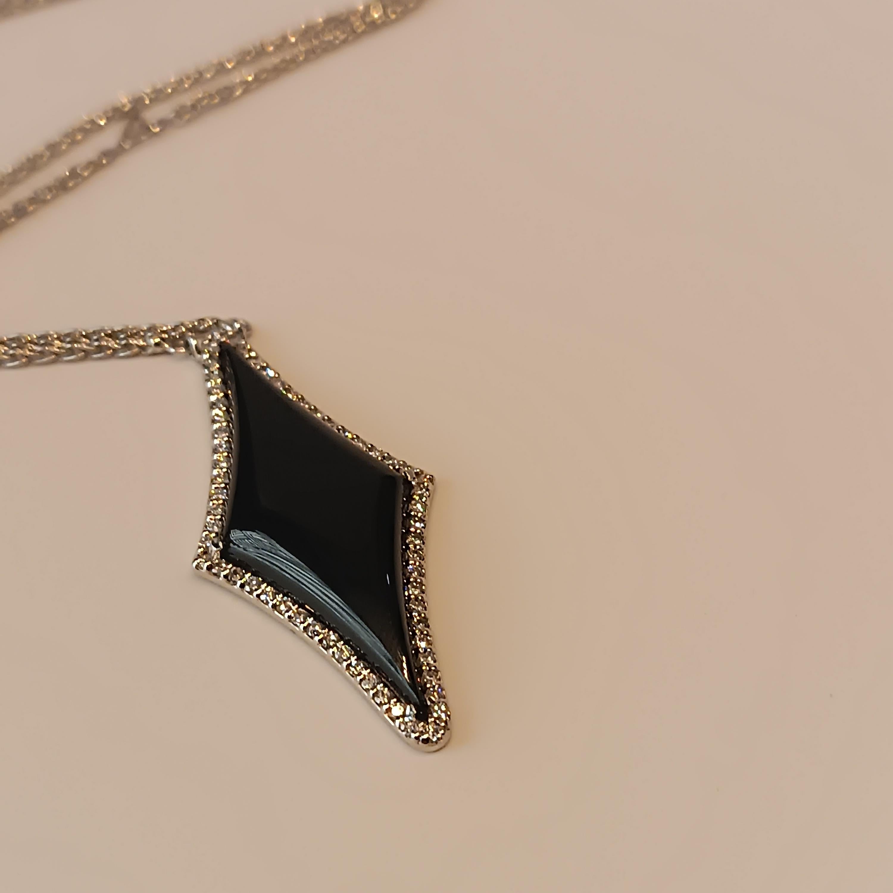This wonderful Leo Milano pendant from our Brera  collection shows in every detail a very complicate yet perfectly done workmanship. The pendant and the chain are in 18 carat white gold with onyx . The object weights 9.63 grams the total diamonds 