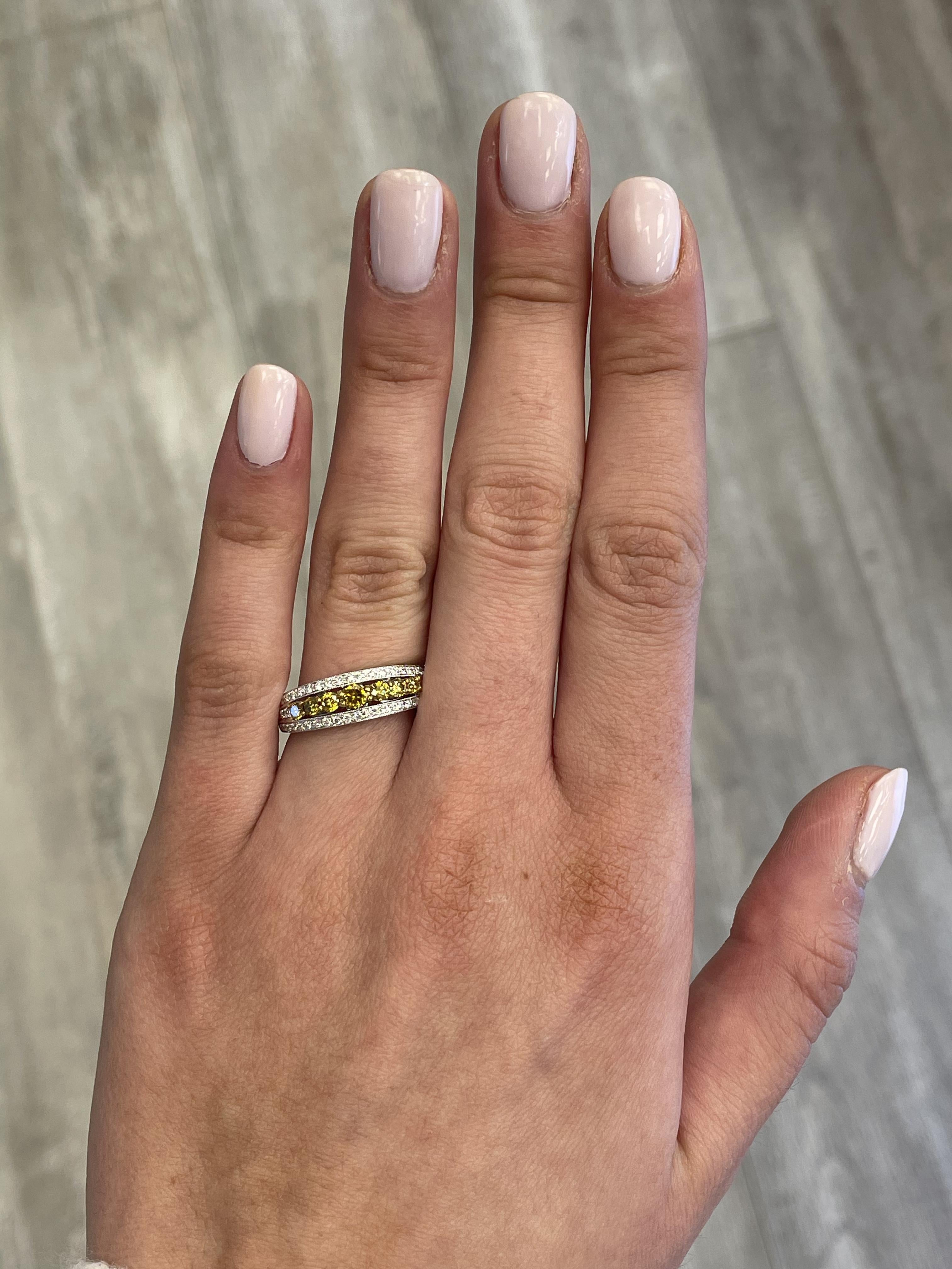 Lovely yellow to brownish yellow diamond cocktail ring.
0.62 carats total diamond weight.
7 round brilliant yellow diamonds, 0.31 carats. Approximately Fancy Yellow - Fancy Brownish Yellow color and SI clarity. Complimented by 54 round diamonds,