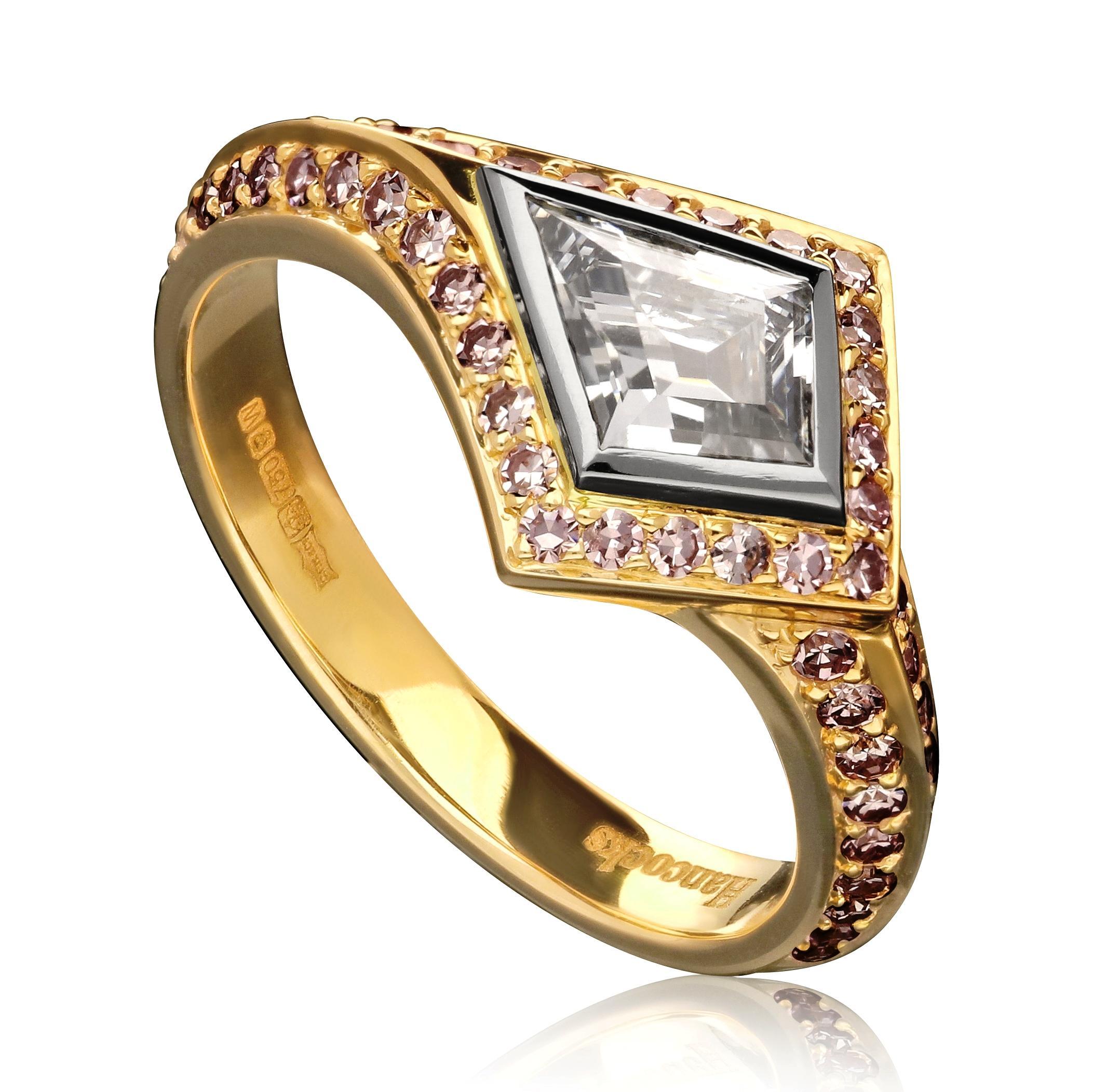 Description
An elegant and unusual fancy coloured diamond and gold ring by Hancocks, centred with a kite-shape step-cut diamond weighing 0.62cts and of Fancy Grey-Blue colour and SI1 clarity rub over set in platinum horizontally placed across the