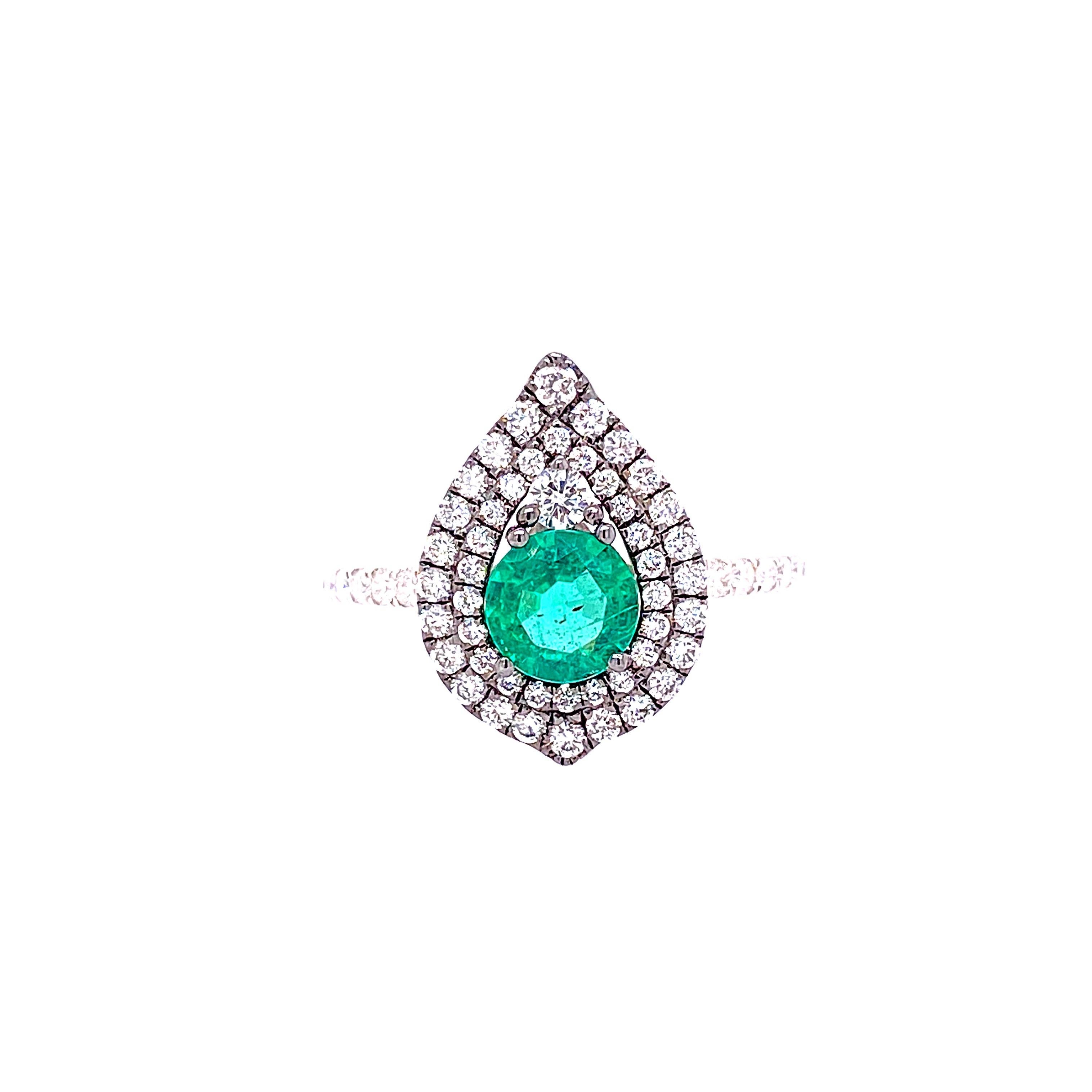 This beautiful ring features a 0.63 Carat Round Emerald with a Double Diamond Halo, that sits on a Diamond Shank. This ring is set in 18K White Gold.
Total Diamond Weight = 0.57 Carats. Ring Size is 6 1/2.