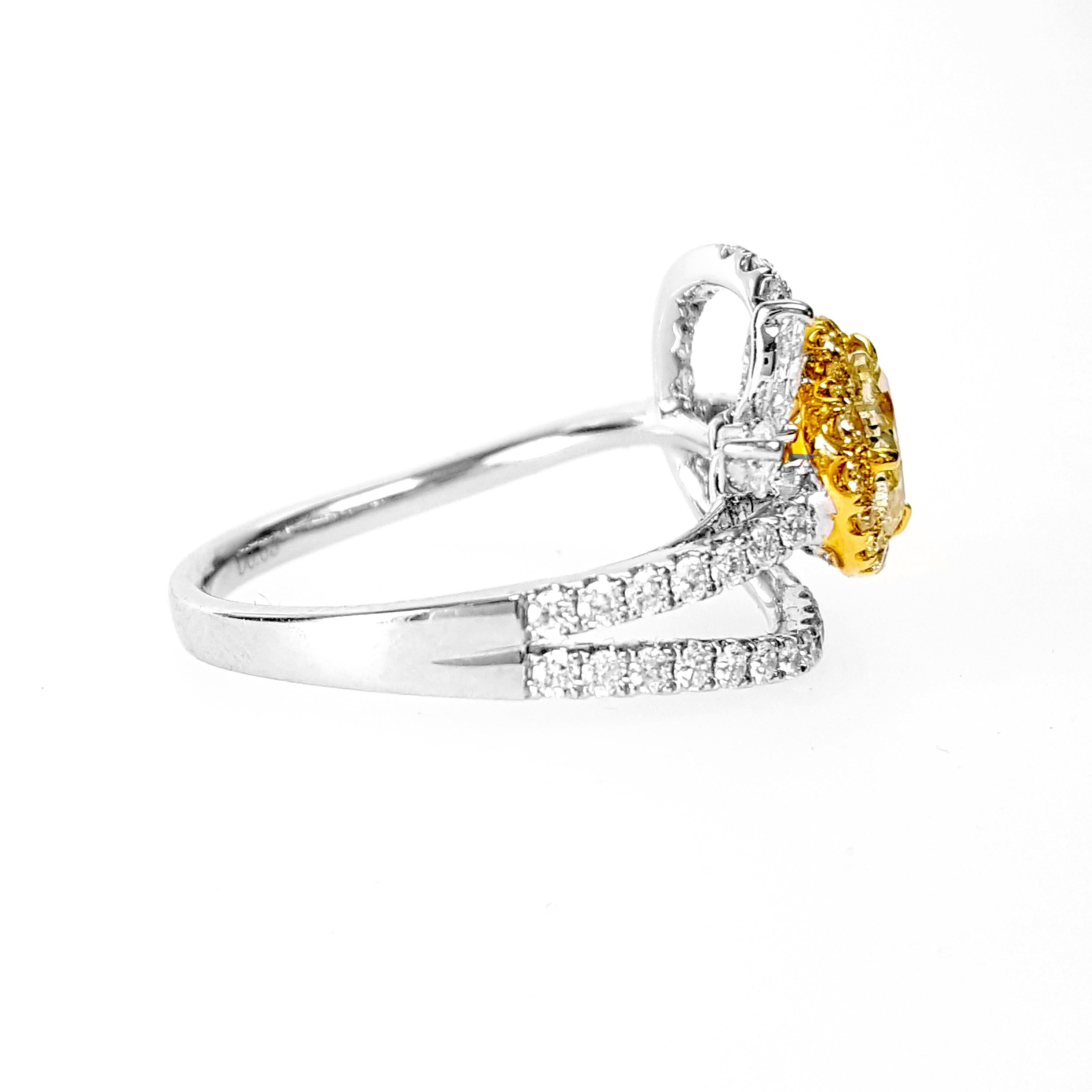 A gorgeous Engagement Cocktail ring Showcasing 0.63 Carat Heart shaped Green-Yellow Diamond, GIA Certified. This exquisite centerpiece is elegantly complemented by a halo of 0.13 Carat Light Yellow Diamonds, which enhance the visual impact of the