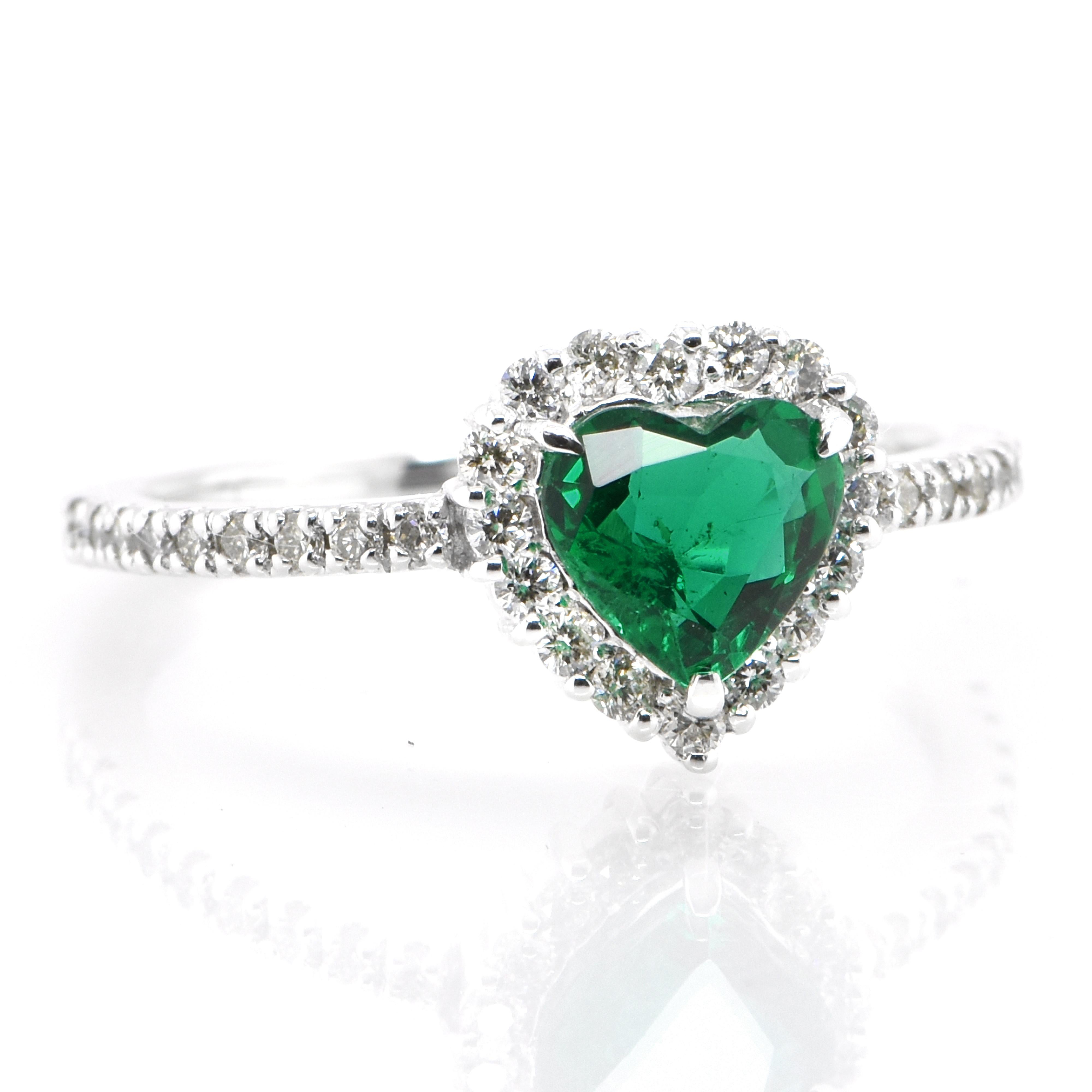 A stunning ring featuring a 0.63 Carat Natural, Heart-Shape, Zambian Emerald and 0.27 Carats of Diamond Accents set in Platinum as well as 18 Karat Yellow Gold. People have admired emerald’s green for thousands of years. Emeralds have always been