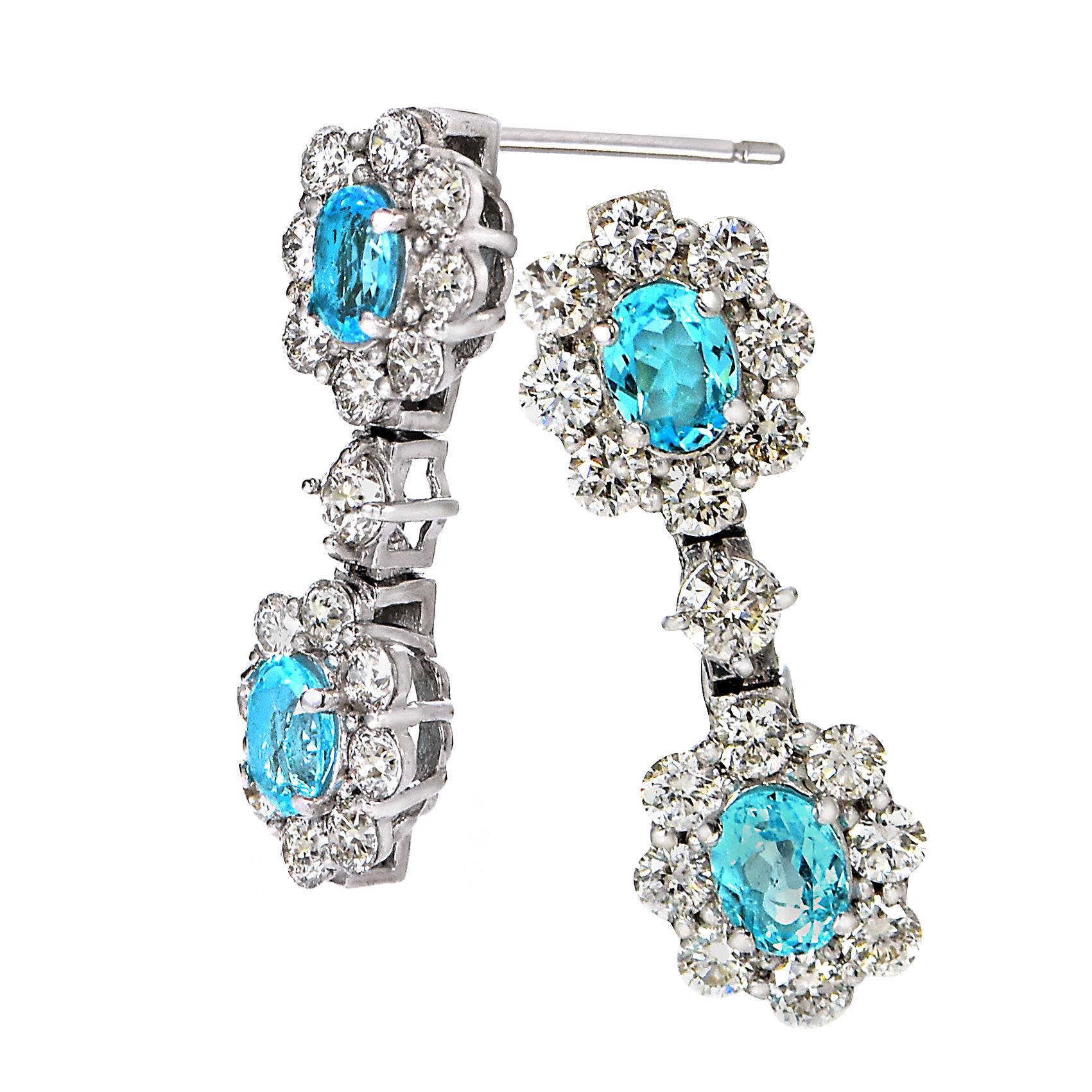 A beautiful pair of earrings featuring a 0.63 Carats of Natural Brazilian Paraiba Tourmaline and 1.04 Carats of Diamond Accents made in Platinum. Paraiba Tourmalines were only discovered 30 years ago in the Brazilian state of the same name- Paraiba.