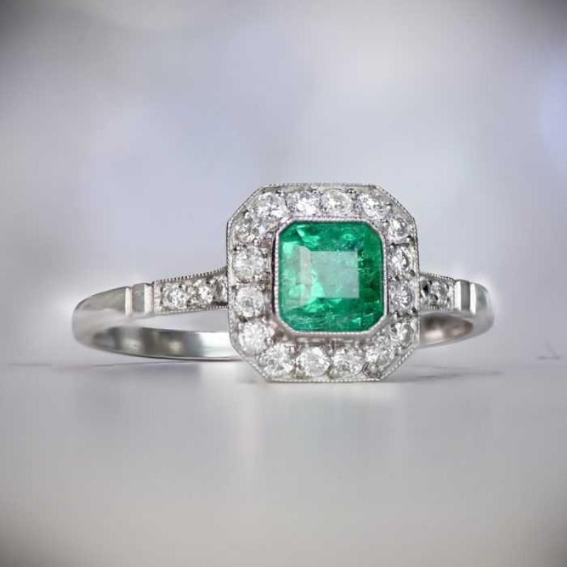 0.63 Emerald Cut Natural Emerald Engagement Ring, Diamond Halo, Platinum In Excellent Condition For Sale In New York, NY