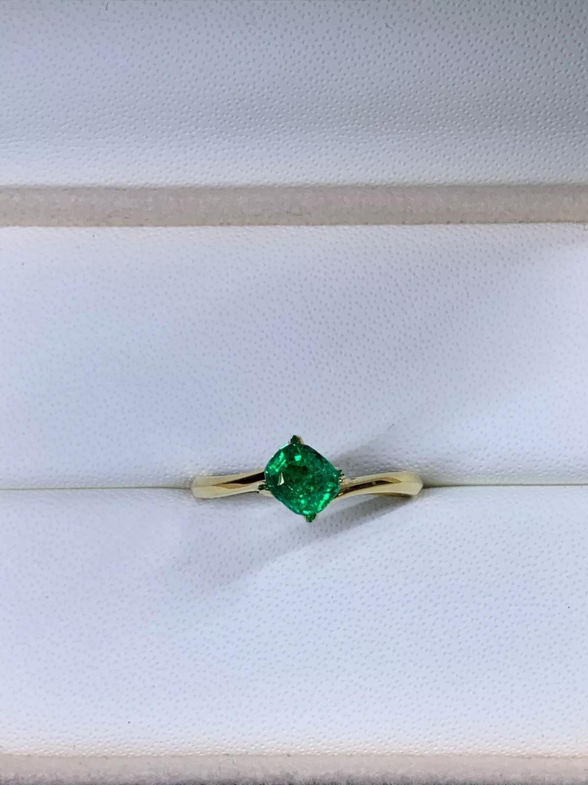0.63ct Green Emerald Solitaire Engagement Ring In 18ct Yellow Gold
This stunning 0.63ct green emerald solitaire engagement ring is the perfect symbol of your love and commitment. Crafted from high-quality 18ct yellow gold, this ring features a
