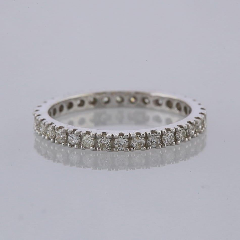 This is a claw set diamond full eternity ring. The ring plays host to 32 round brilliant cut diamonds.

Condition: Used (Very Good)
Weight: 2.2 grams
Size: N
Band Width: 2mm
Total Diamond Carat Weight: Approx. 0.64 carats
Diamond Details: Colour: