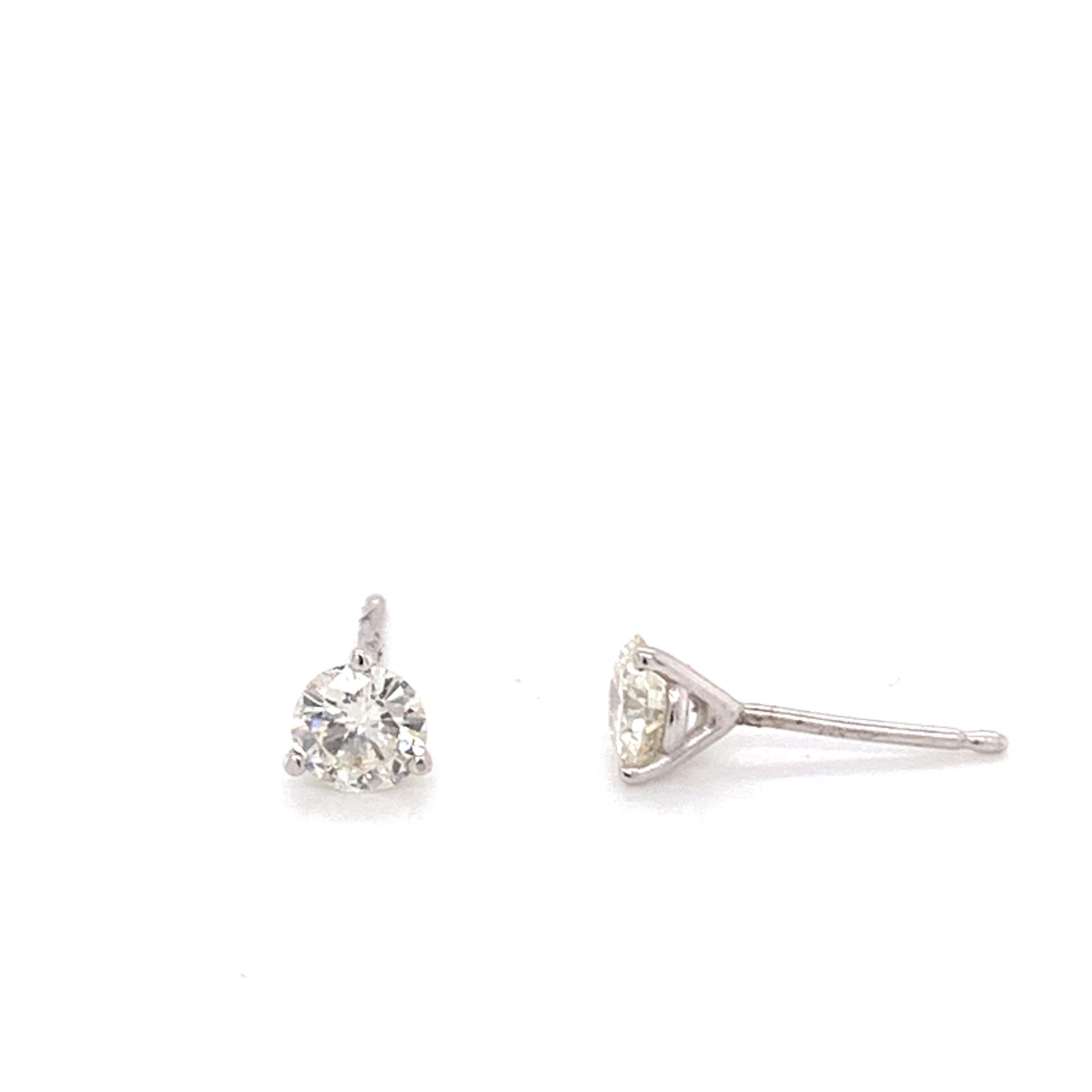 Diamond Stud Earrings made with real/natural brilliant cut diamonds. Total Diamond Weight: 0.64 carats. Diamond Quantity: 2 (round diamonds).  Mounted on 14 carat white gold push back setting.