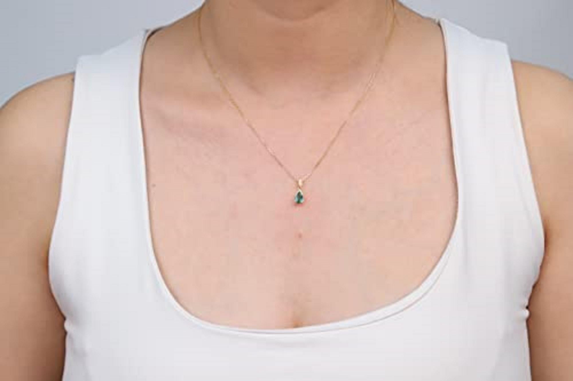 Decorate yourself in elegance with this Pendant is crafted from 10-karat Yellow Gold by Gin & Grace. This Pendant is made up of Pear-Cut Emerald (1 pcs) 0.64 carat and Round-cut White Diamond (10 Pcs) 0.04 Carat. This Pendant is weight 1.81 grams.