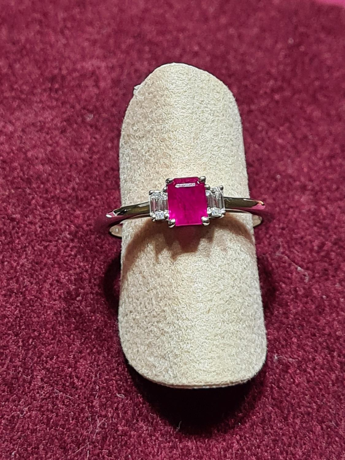 Beautiful modern solitaire ring. New ring with tags. The ring consists of white gold with 0.64 Ct natural ruby octagon cut and 0.17 Ct diamonds round cut.
Total weight: 2.38 grams
Metal: white gold 18Kt
New contemporary jewelry. 
US Ring size 6,5.