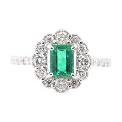 0.645 Carat Natural Emerald and Diamond Halo Ring Set in Platinum