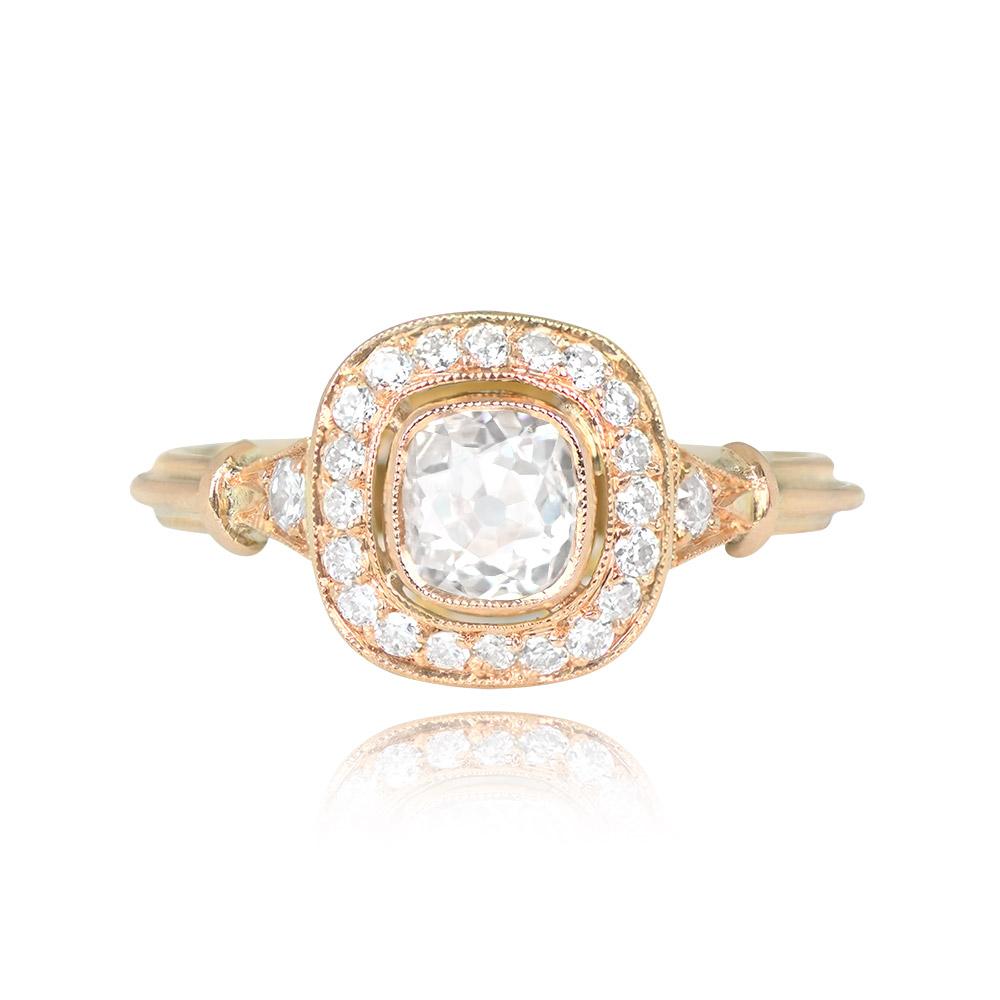 This ring features a 0.64-carat antique cushion-cut diamond (I color, SI1 clarity) in a bezel setting. It is adorned with a halo of old European cut diamonds and has additional old European cut diamonds on the tapered shoulders. Handcrafted in 18k