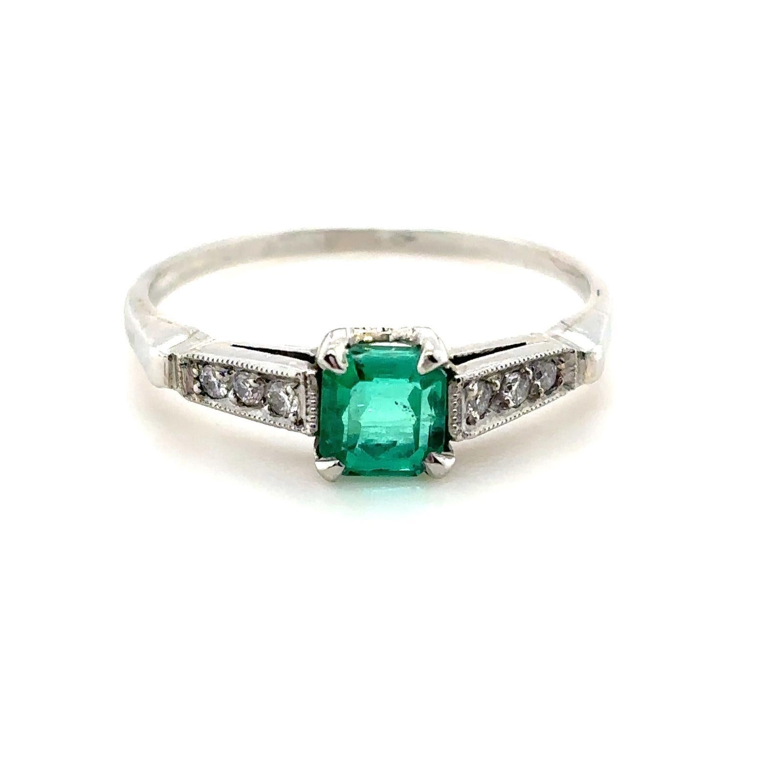 A 0.65 carat Columbian emerald and diamond platinum engagement ring.

This beautiful emerald and diamond ring is handcrafted in platinum. Claw set to its centre with an emerald cut emerald of 0.65 carats. This striking stone is a rich, deep green,