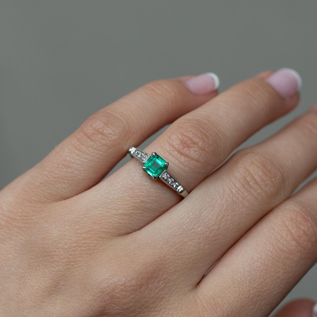Emerald Cut 0.65 carat Columbian emerald and diamond platinum engagement ring. For Sale