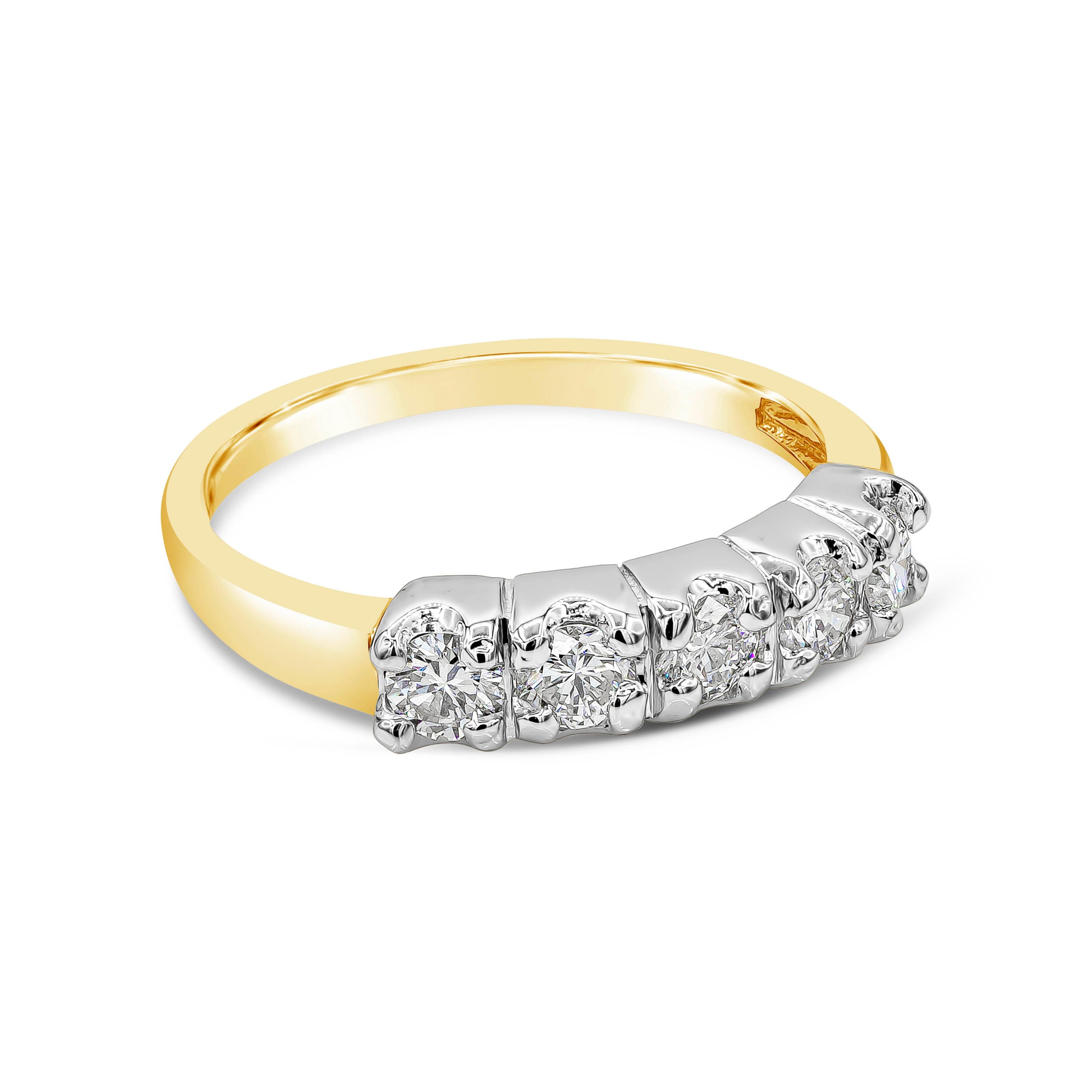 A uniquely-designed five-stone wedding band showcasing five round brilliant diamonds, each set in a classic four-prong basket setting made in 14k white gold. Diamonds weigh 0.65 carats total and are approximately H color, VS clarity. Band made in